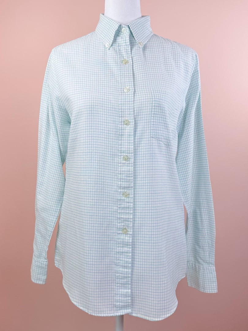 White preppy checkered button down shirt for women from the 1980s, featuring a classic collar and long sleeves.