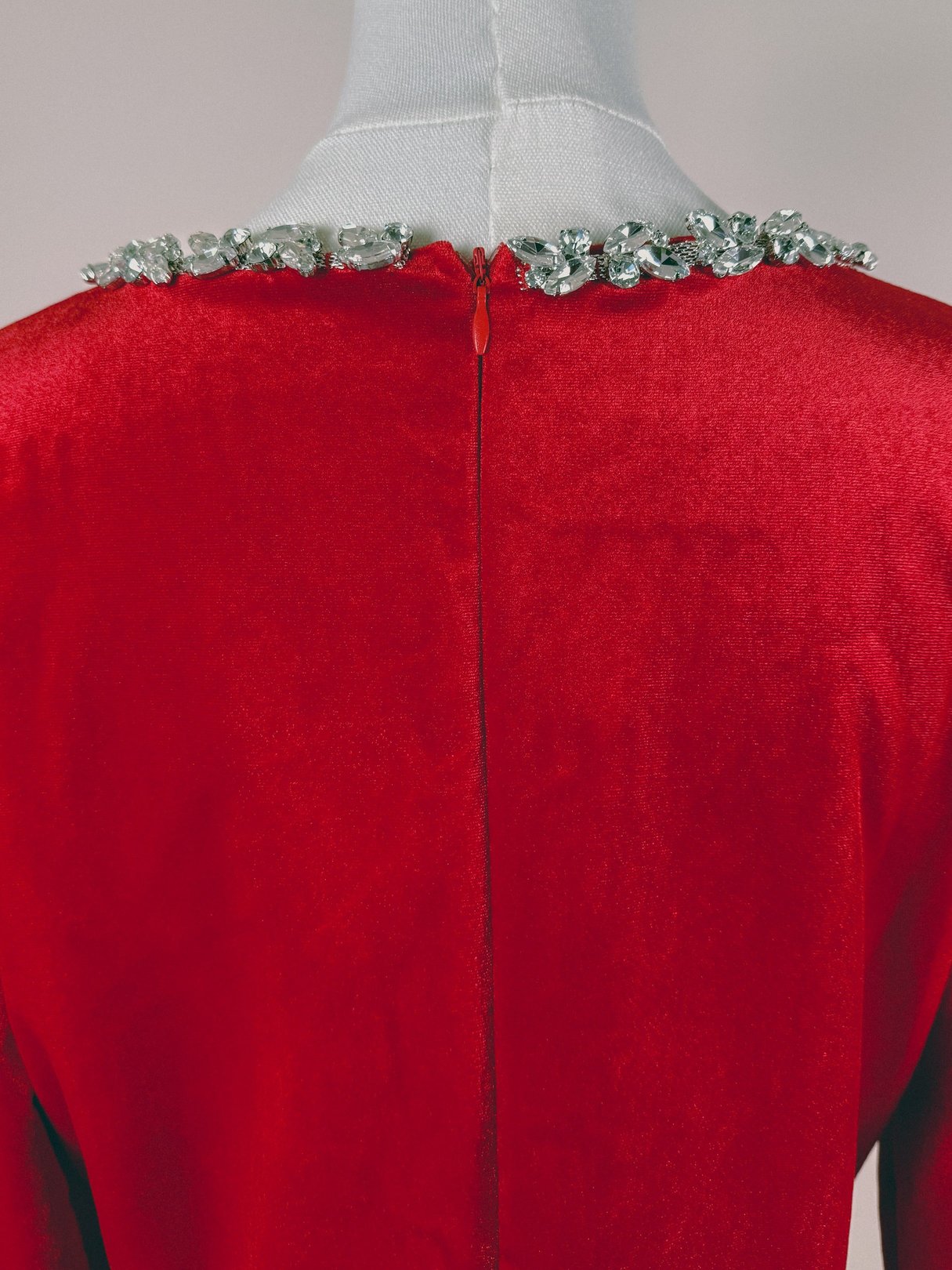 A women's 1970s red velvet dress featuring a jeweled neckline.