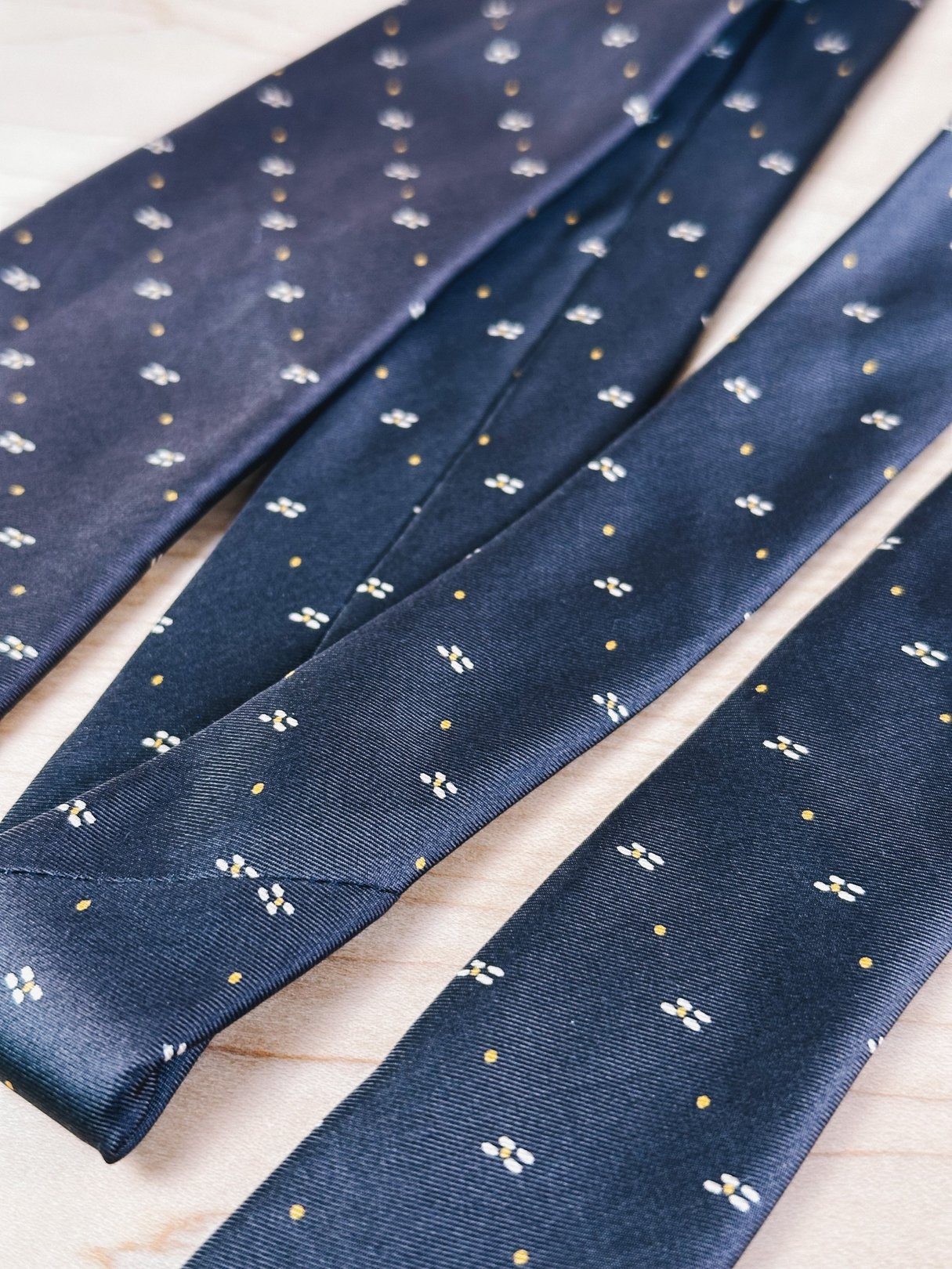 1970s women's brown tie with a yellow dot pattern, featured in a close-up view.