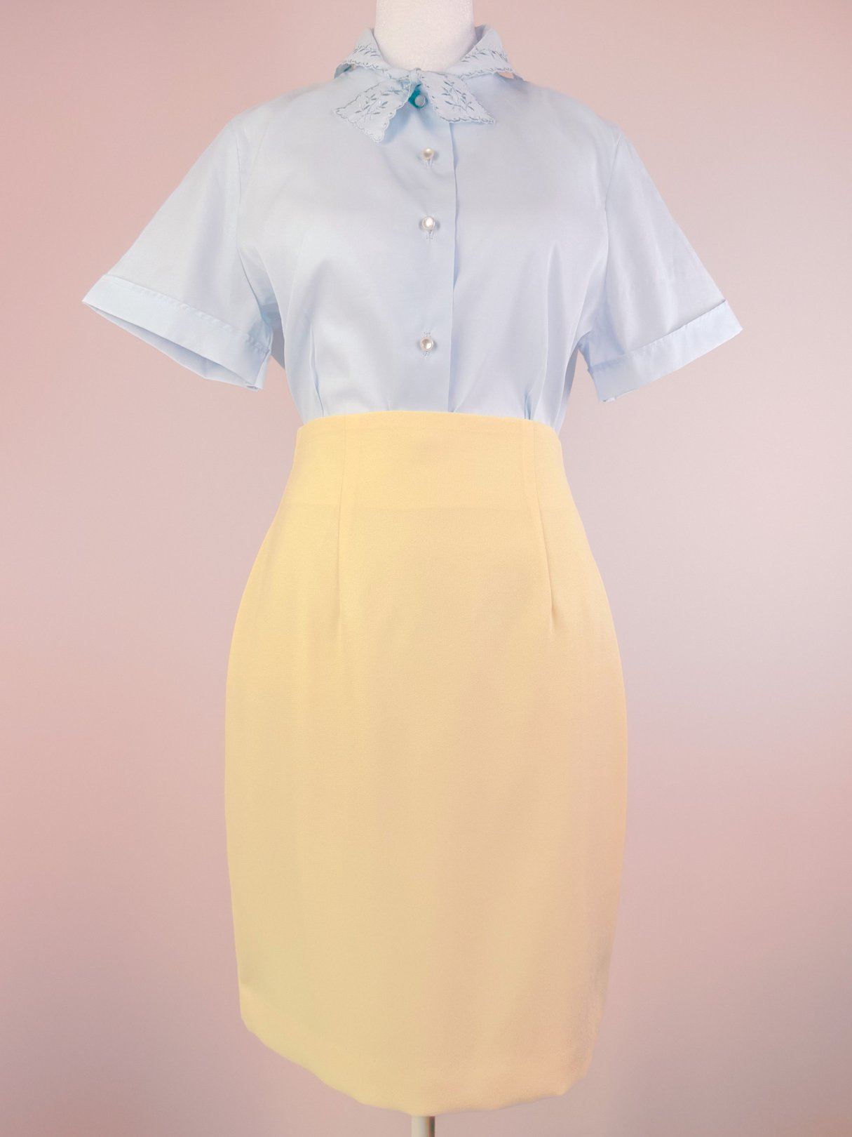 Buttery yellow 1990s women's skirt styled with a light blue blouse featuring a collar and buttons.