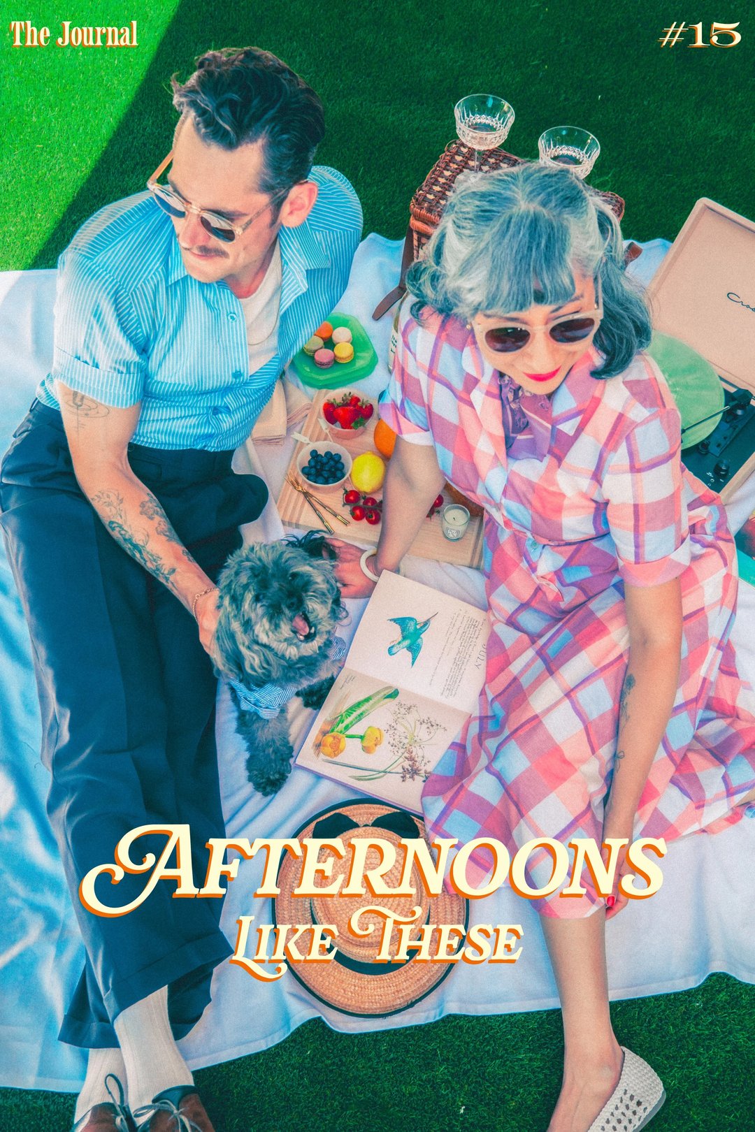 A stylish couple sits on a picnic blanket with a small dog, surrounded by fruits and a book, under bright sunlight.