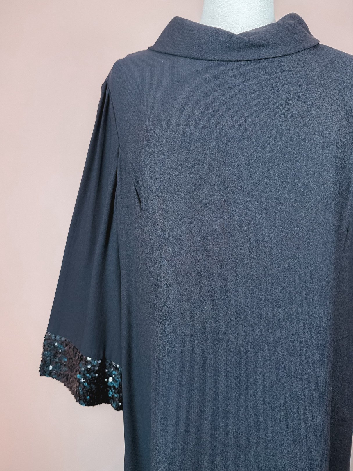 Black Mod Sparkle Dress for women featuring a 1960s style with sequin-embellished sleeves.