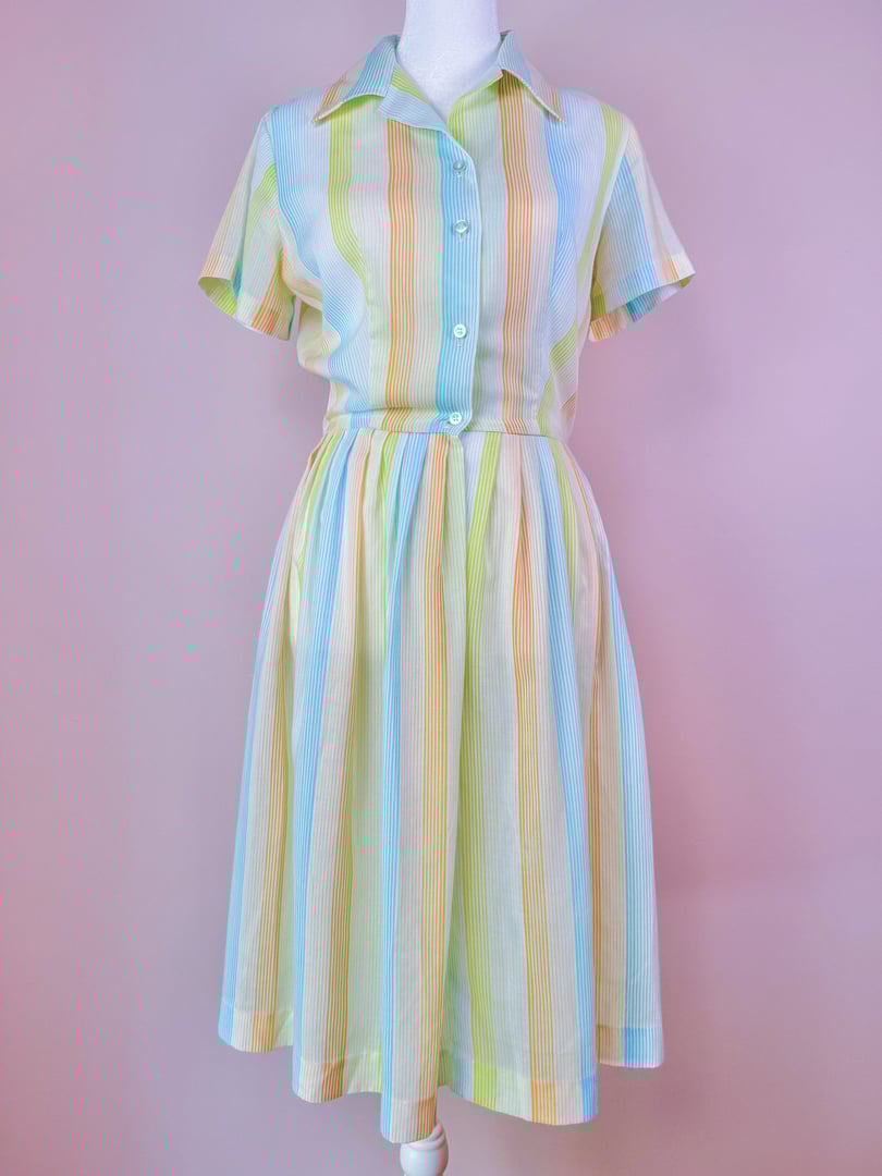 Short-sleeved 1950s-style citrus dress featuring vertical stripes in orange, blue, and yellow colors.
