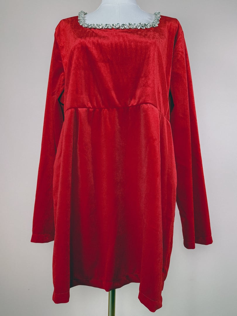 Red velvet dress with a square neckline and embellished trim, featuring long sleeves and a relaxed fit, representative of 1970s fashion for women.