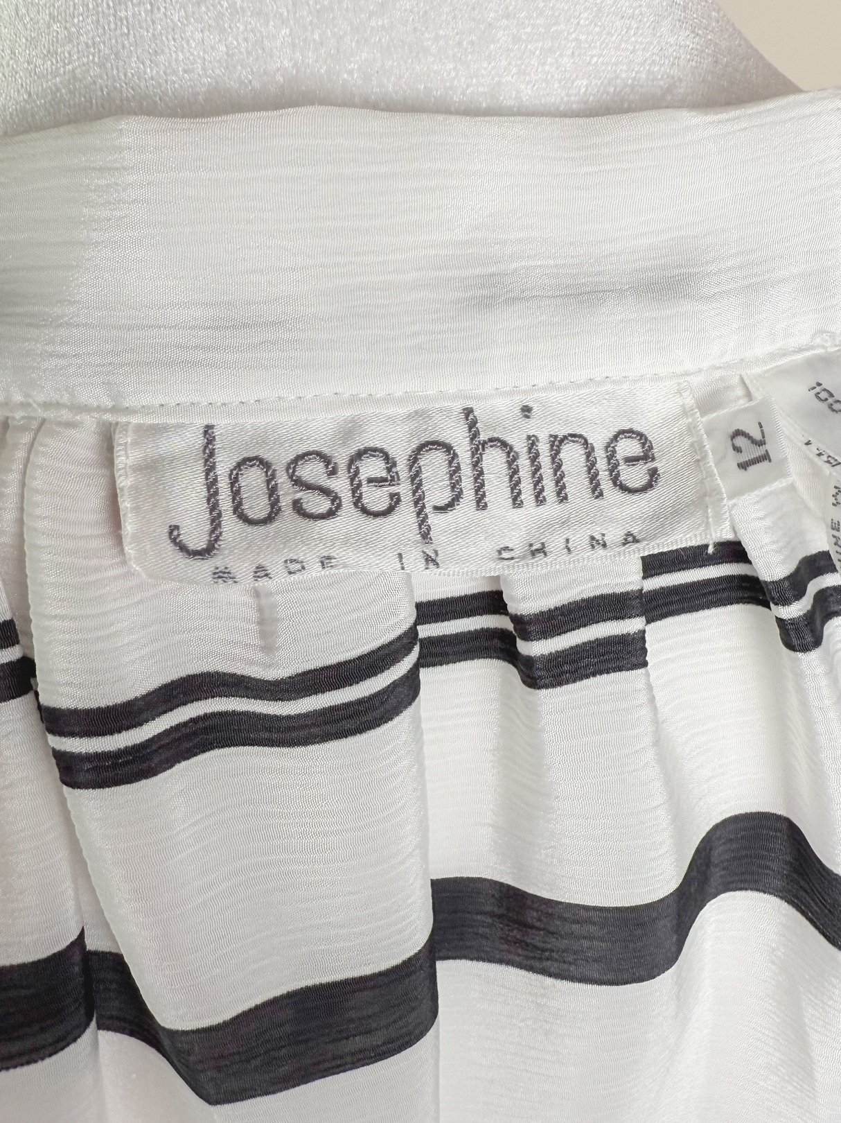 1970s women's white skirt with a striped pattern, featuring a label that reads "Josephine.