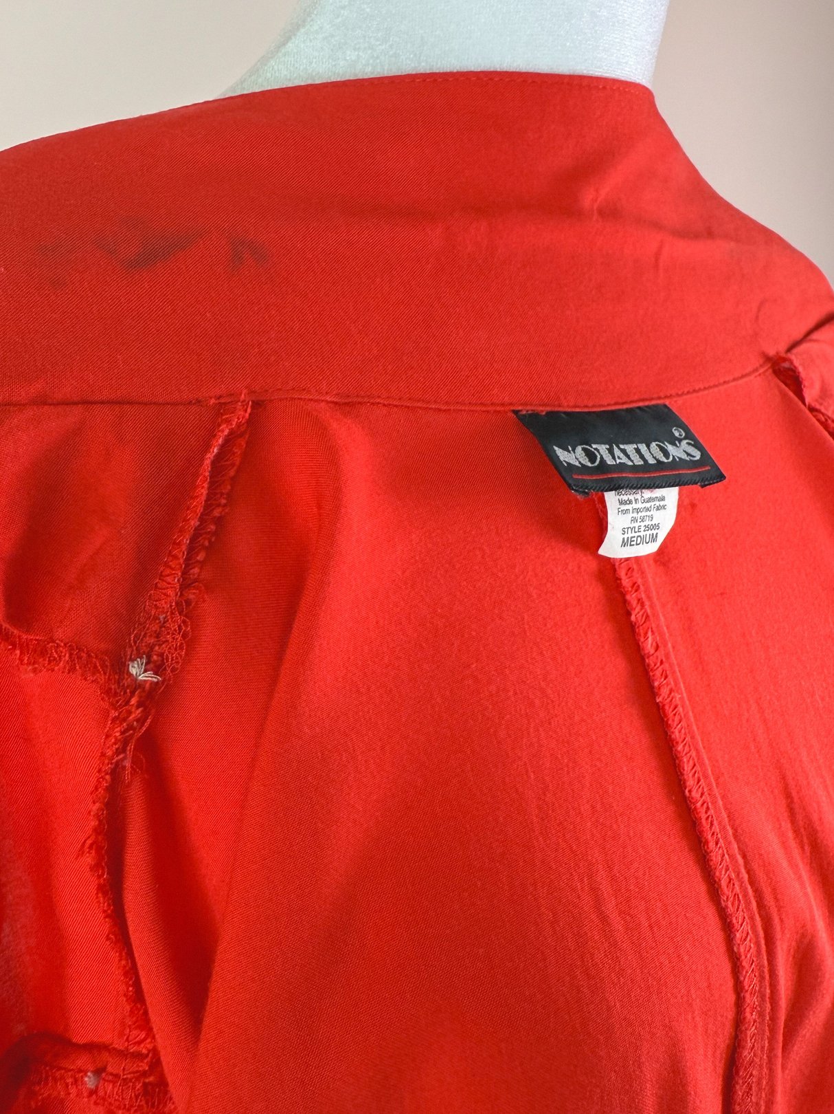 Red 1980s women's top with a tag labeled "Notations" and frayed edges.