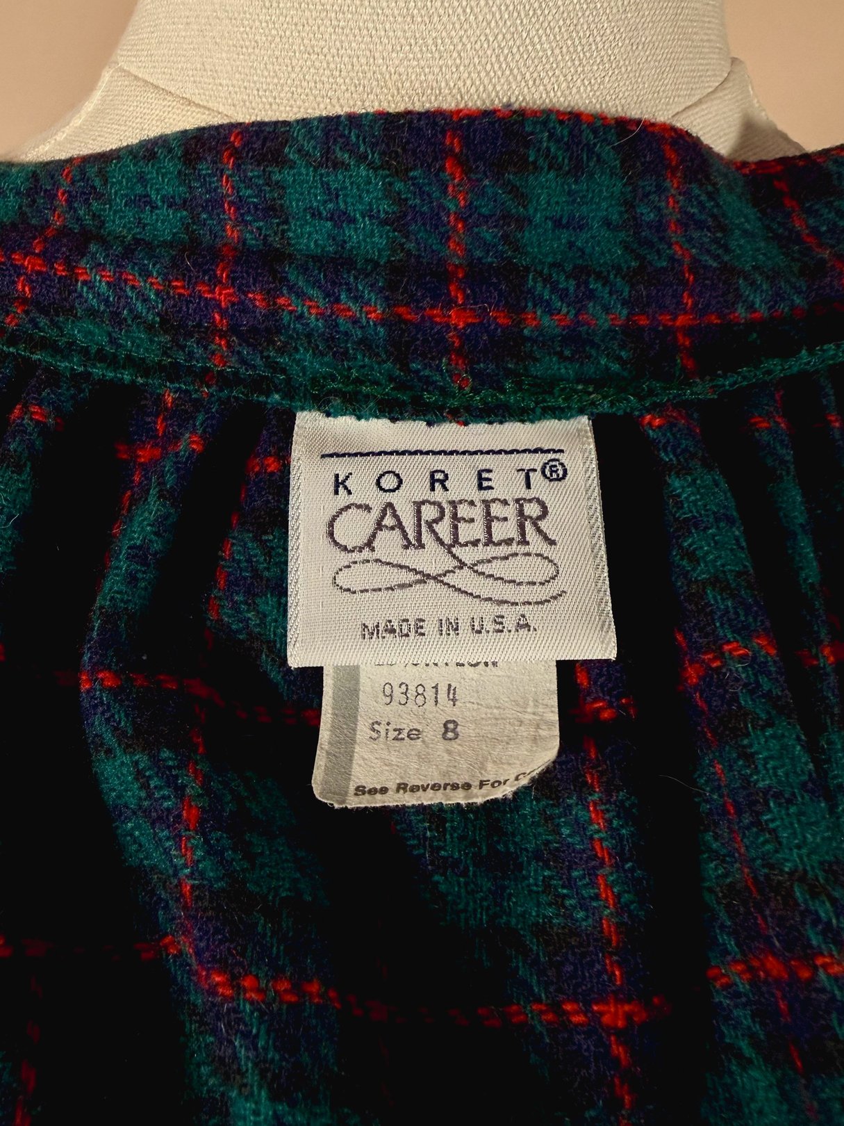 Koret Career label on a green plaid skirt from the 1970s, size 8.