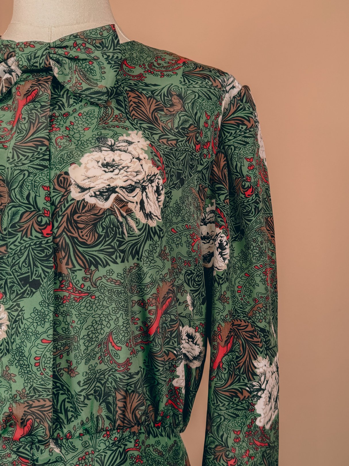 Red floral printed top with a bow neckline, featuring a 1980s design suitable for women.