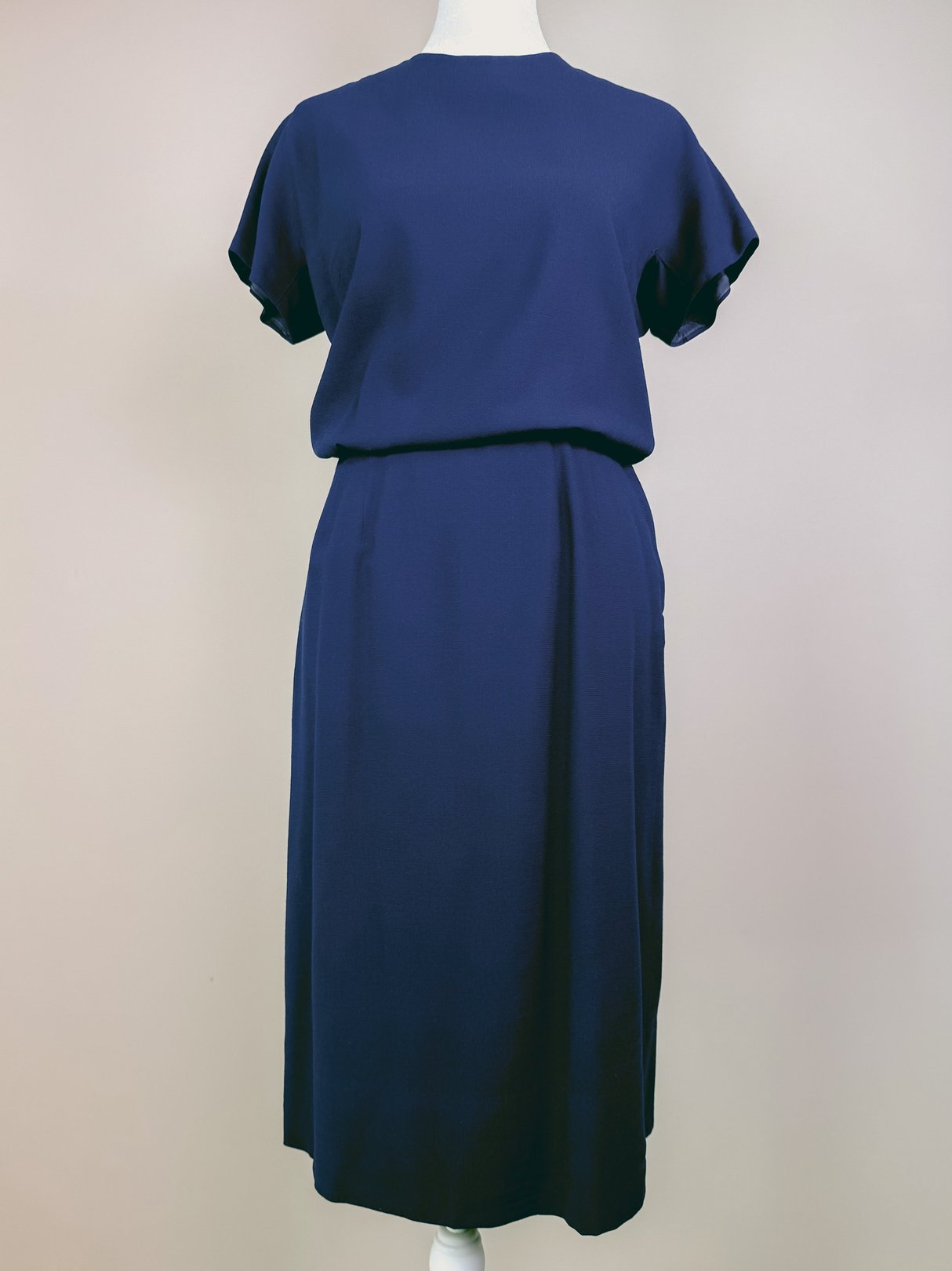 Navy blue 1960s women's dress set featuring short flutter sleeves and a fitted waist.