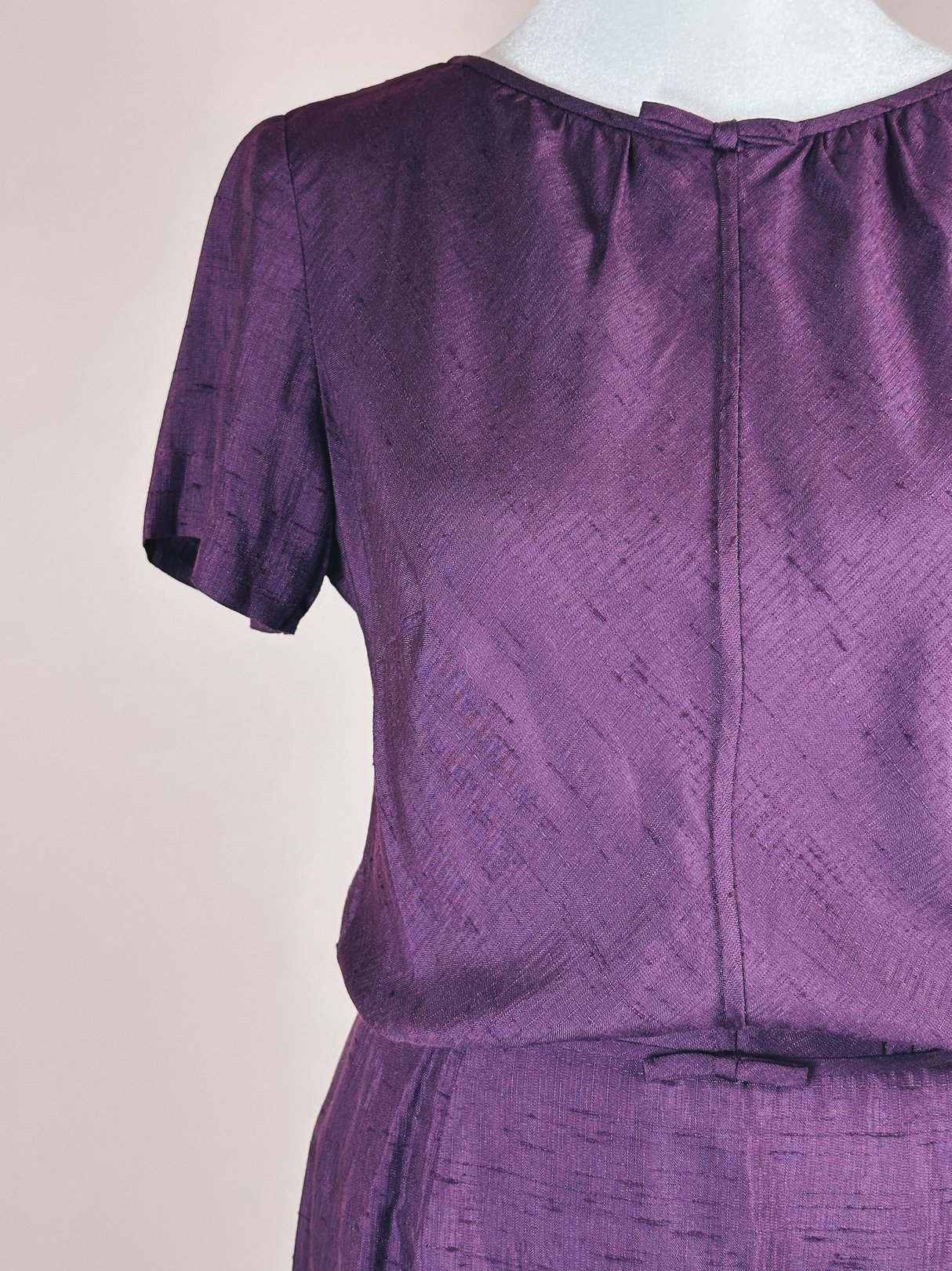 Purple Royalty Bow Dress featuring a short-sleeved design and a bow detail at the waist, representative of the 1960s fashion era.