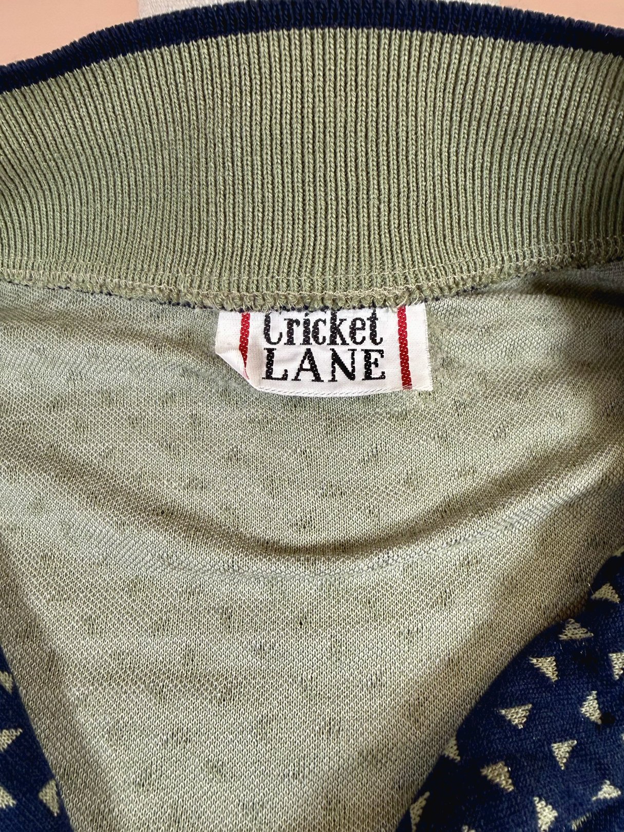 Navy blue women's triangle top from Cricket Lane featuring a label from the 1980s.