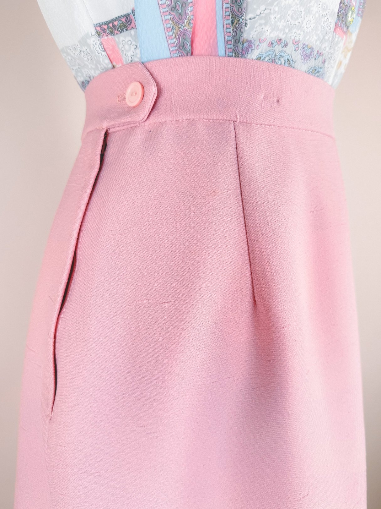 Blush pink fabric detail from a 1970s women's three-piece suit by Lilli Ann.