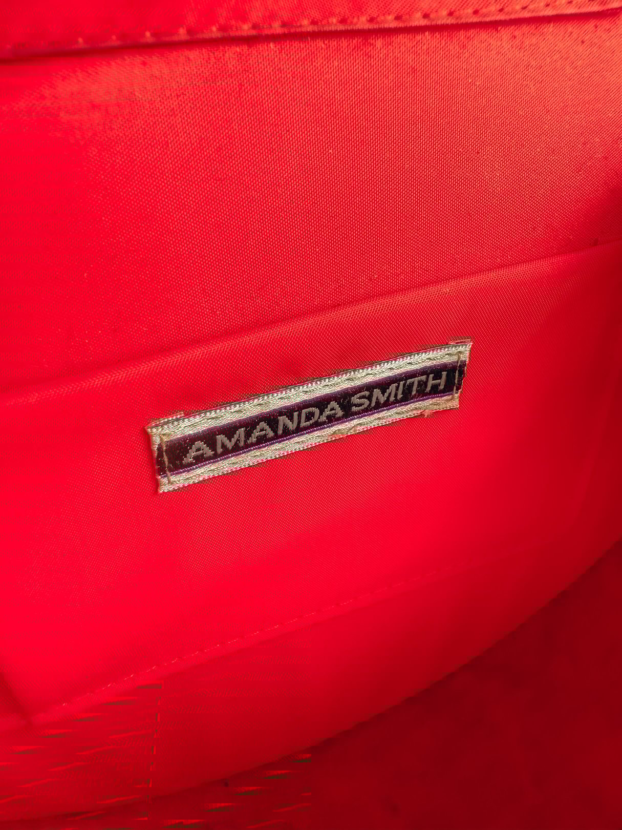 Black velvet purse from the 1970s for women, featuring a label that reads "Amanda Smith.