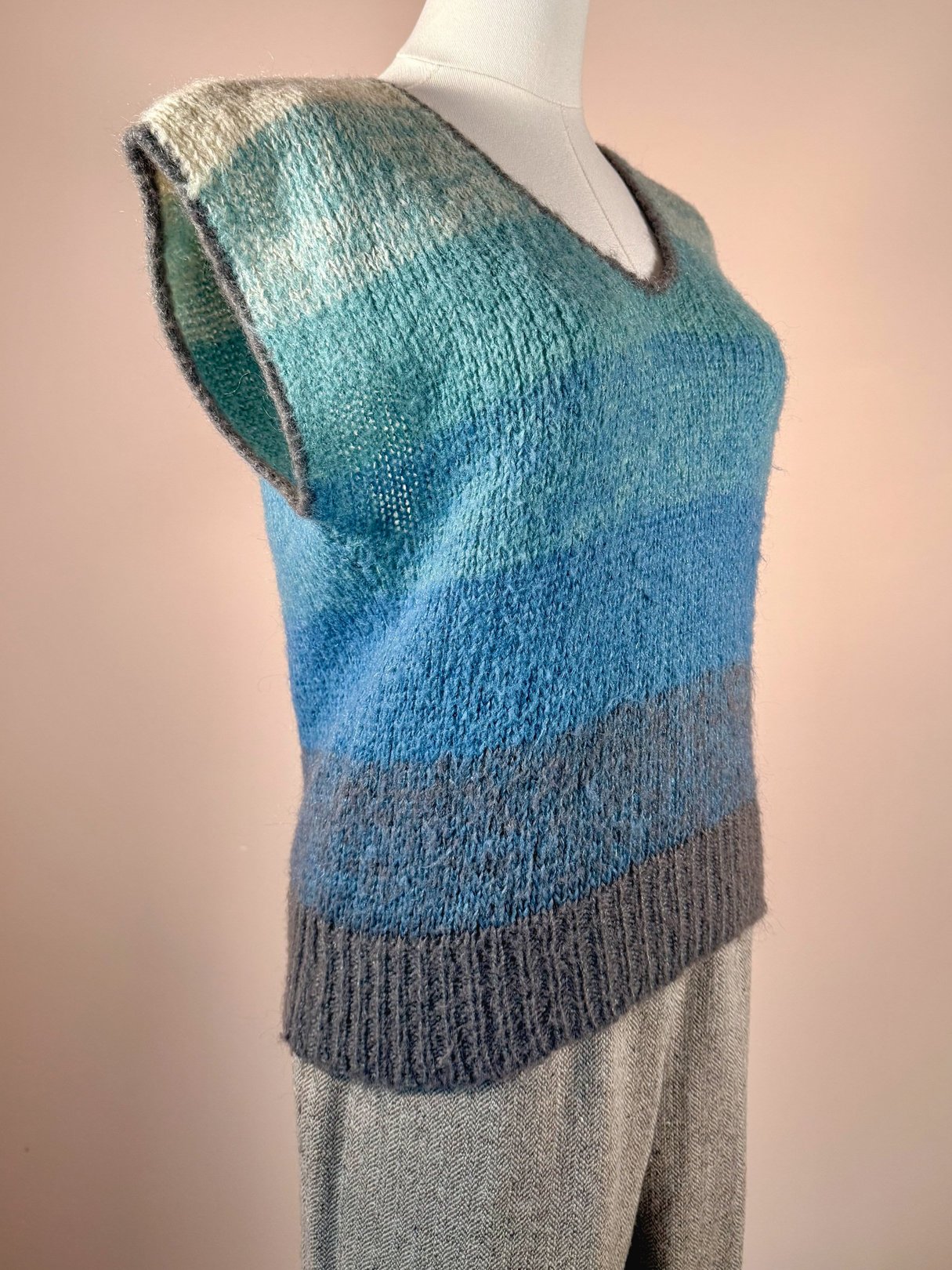1970s women's mohair sweater vest featuring a gradient in shades of blue and gray, with a V-neckline and sleeveless design.