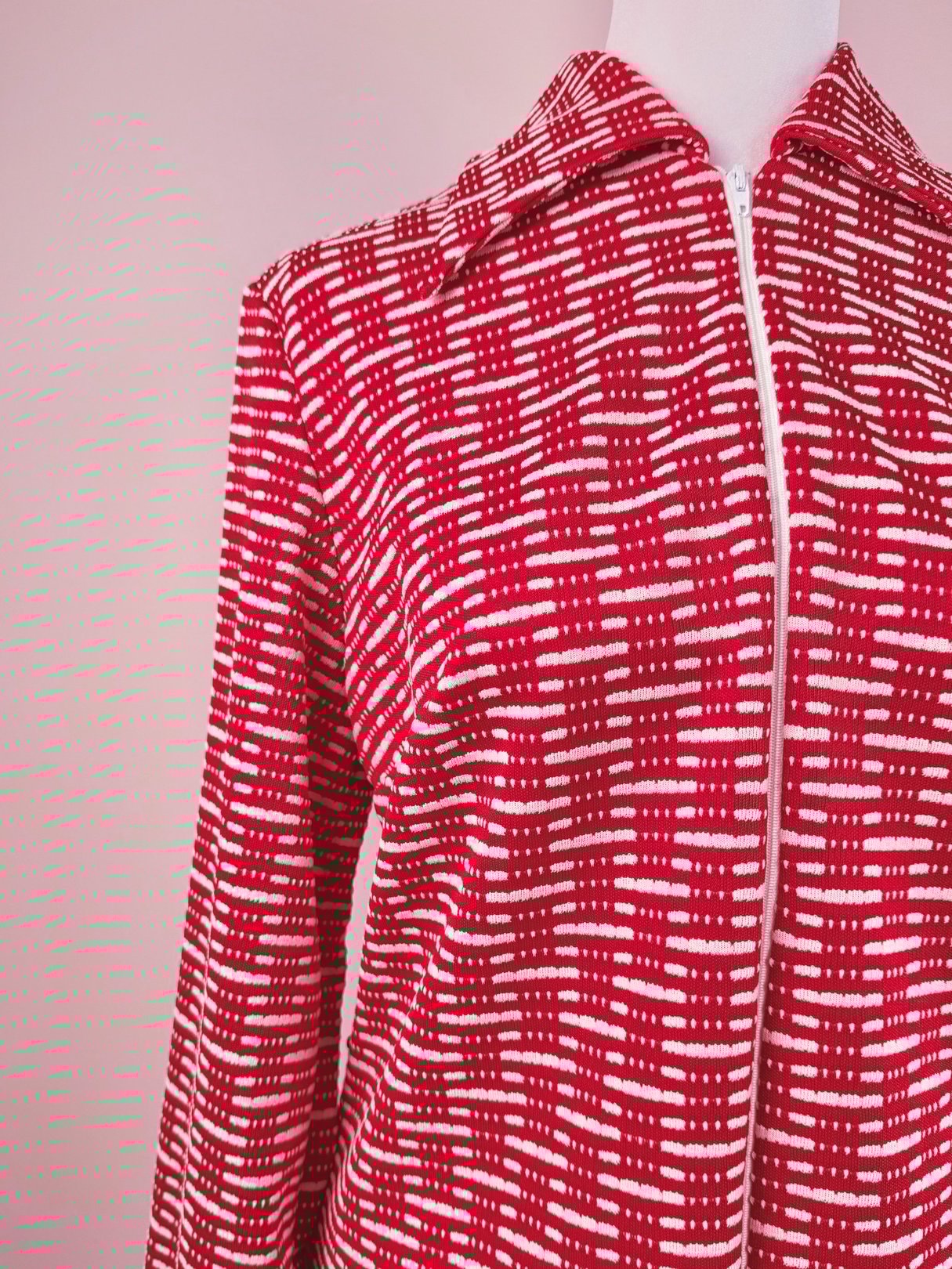 Red 1970s women's knit dress featuring a zip front and a geometric pattern.