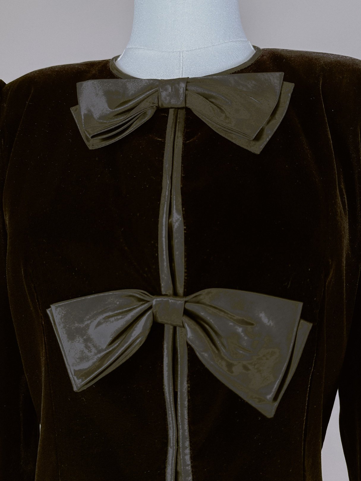 Black velvet jacket for women from the 1980s featuring two large decorative bows on the front.
