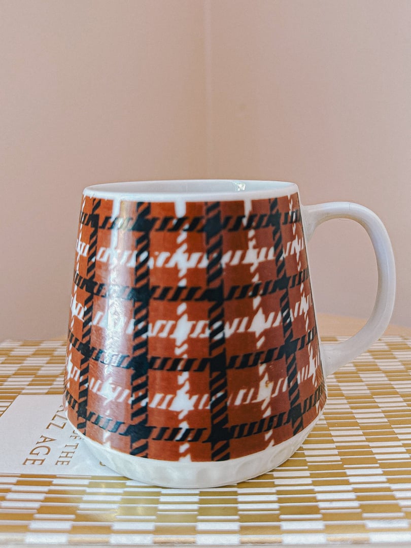 Houndstooth print ceramic mug featuring a black and brown design, reflective of 1970s home décor style.