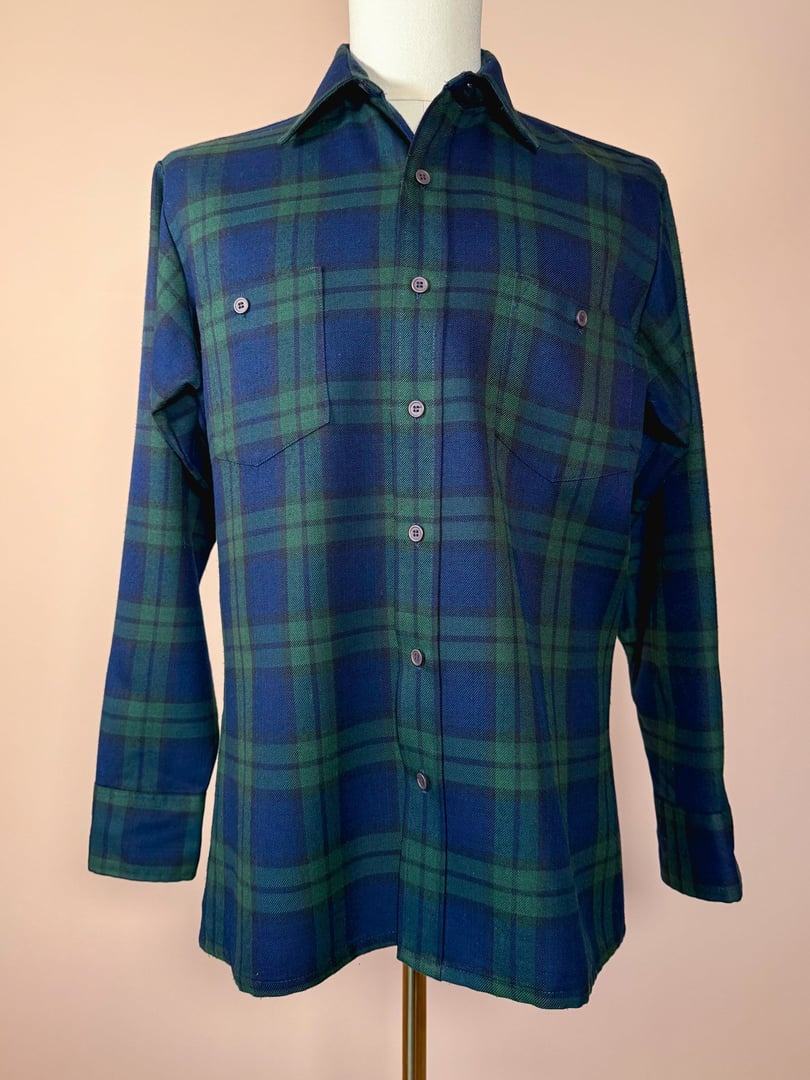 Navy blue and green plaid shirt with a button-down front, two chest pockets, and long sleeves, designed for men.