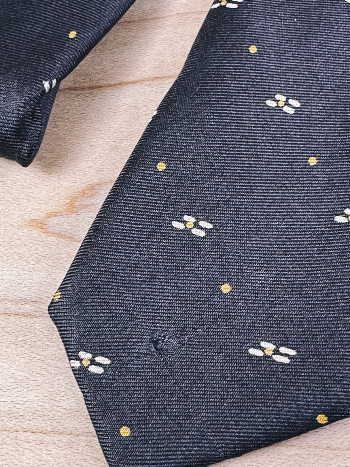 Brown tie featuring a yellow dot and floral pattern, styled for women and dating from the 1970s.