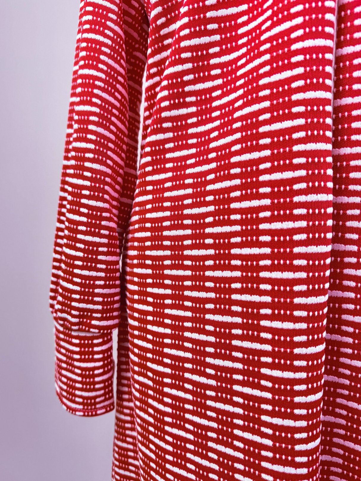 Red 1970s women's knit dress featuring a textured pattern with alternating white lines.