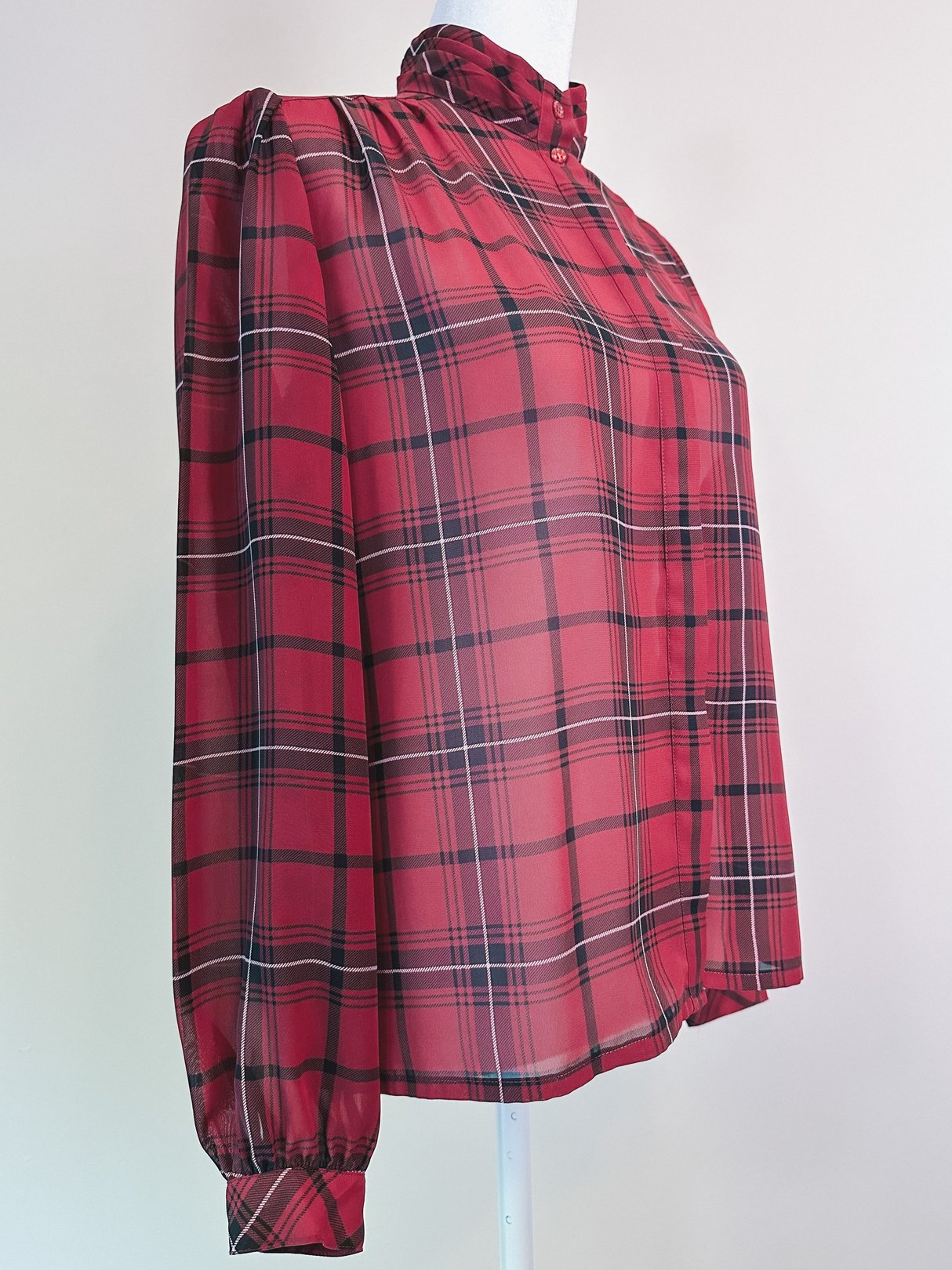 Maroon plaid blouse with a high neckline and puffed sleeves, reflecting a 1960s style for women.