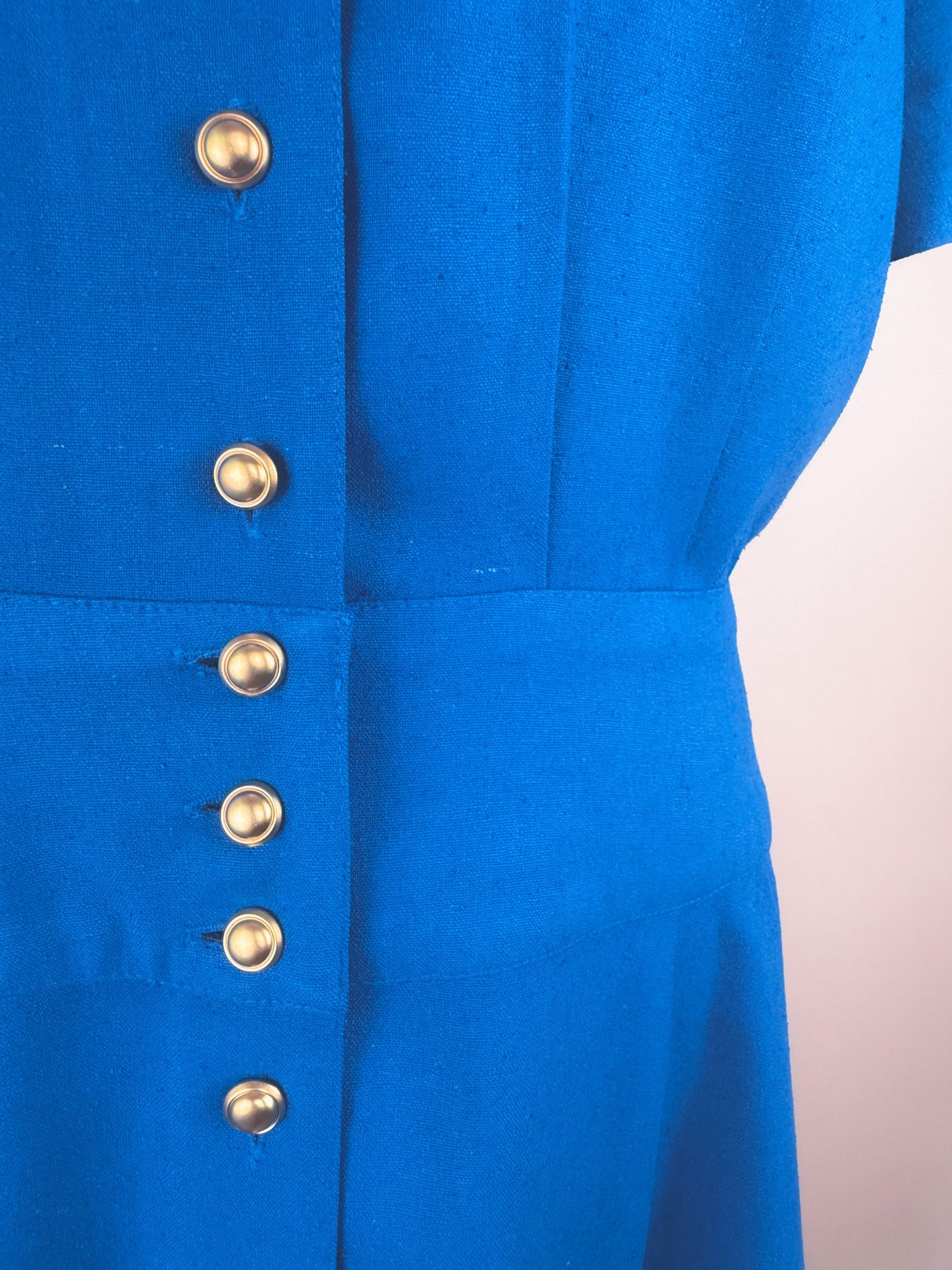 Cerulean blue 1980s women's dress featuring a button-up front.
