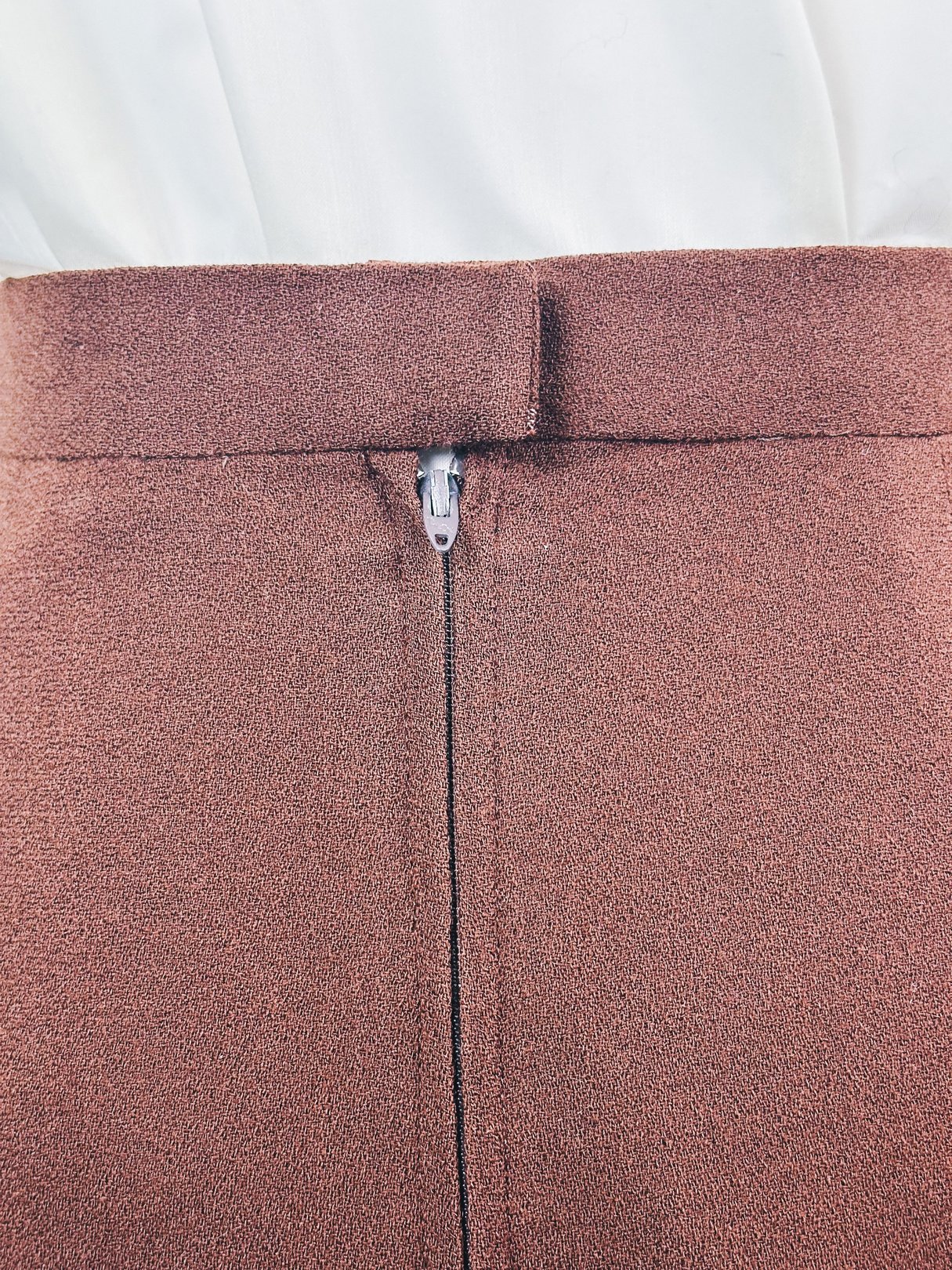 Brown women's skirt from the 1970s featuring a zipper closure.