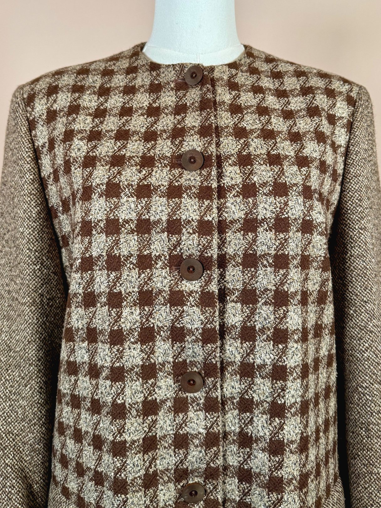 Brown tweed coat featuring a checkered pattern and button closures.