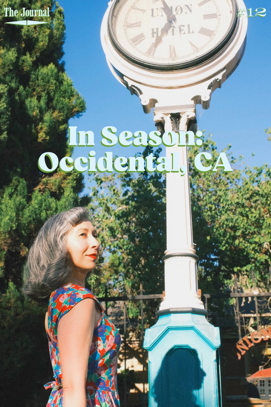 A woman in a colorful dress stands beside a vintage clock in Occidental, California, with text overlay reading "In Season: Occidental, CA.