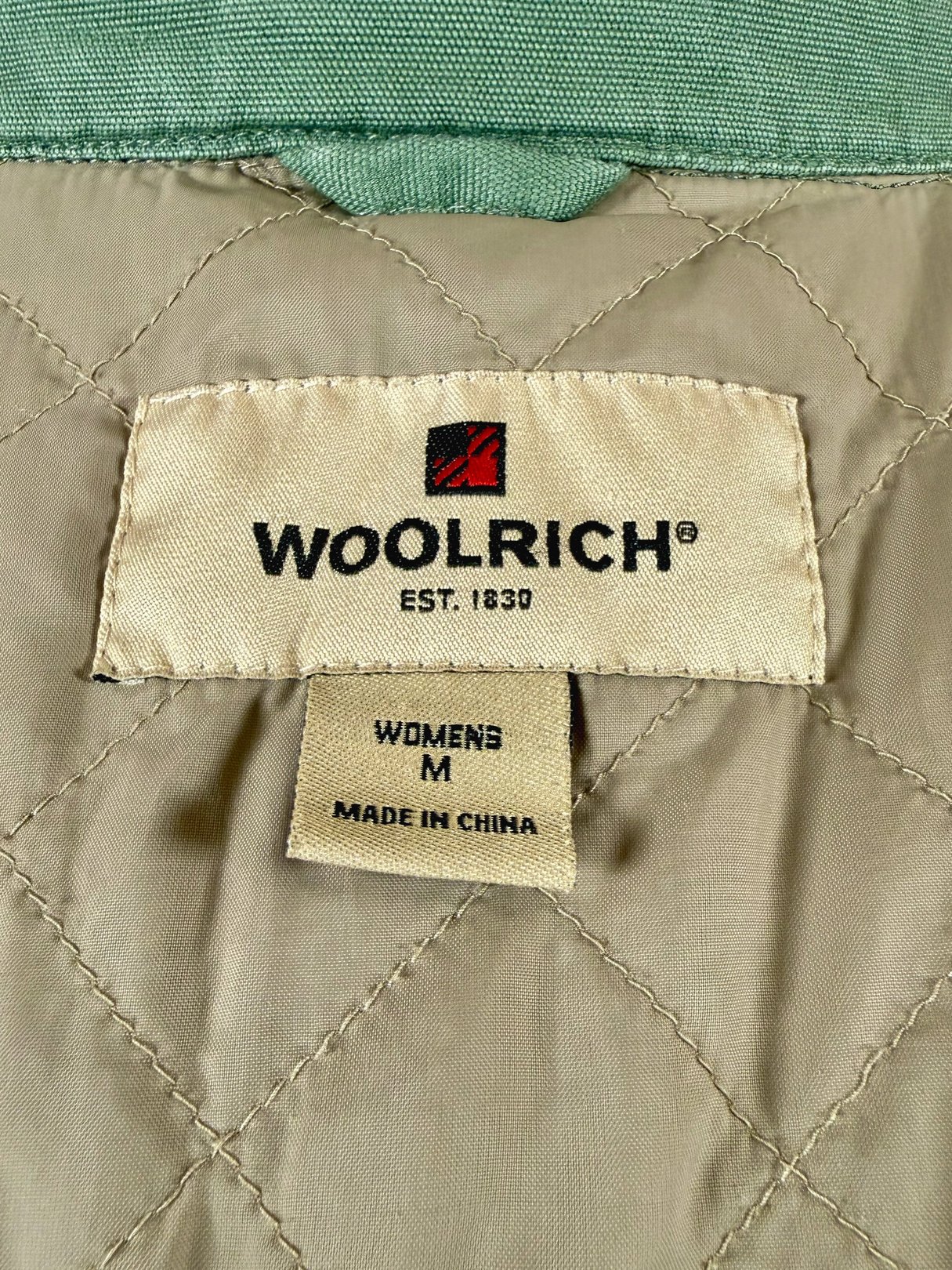 Sage Quilted Woolrich jacket for women, label shows size medium, made in China.
