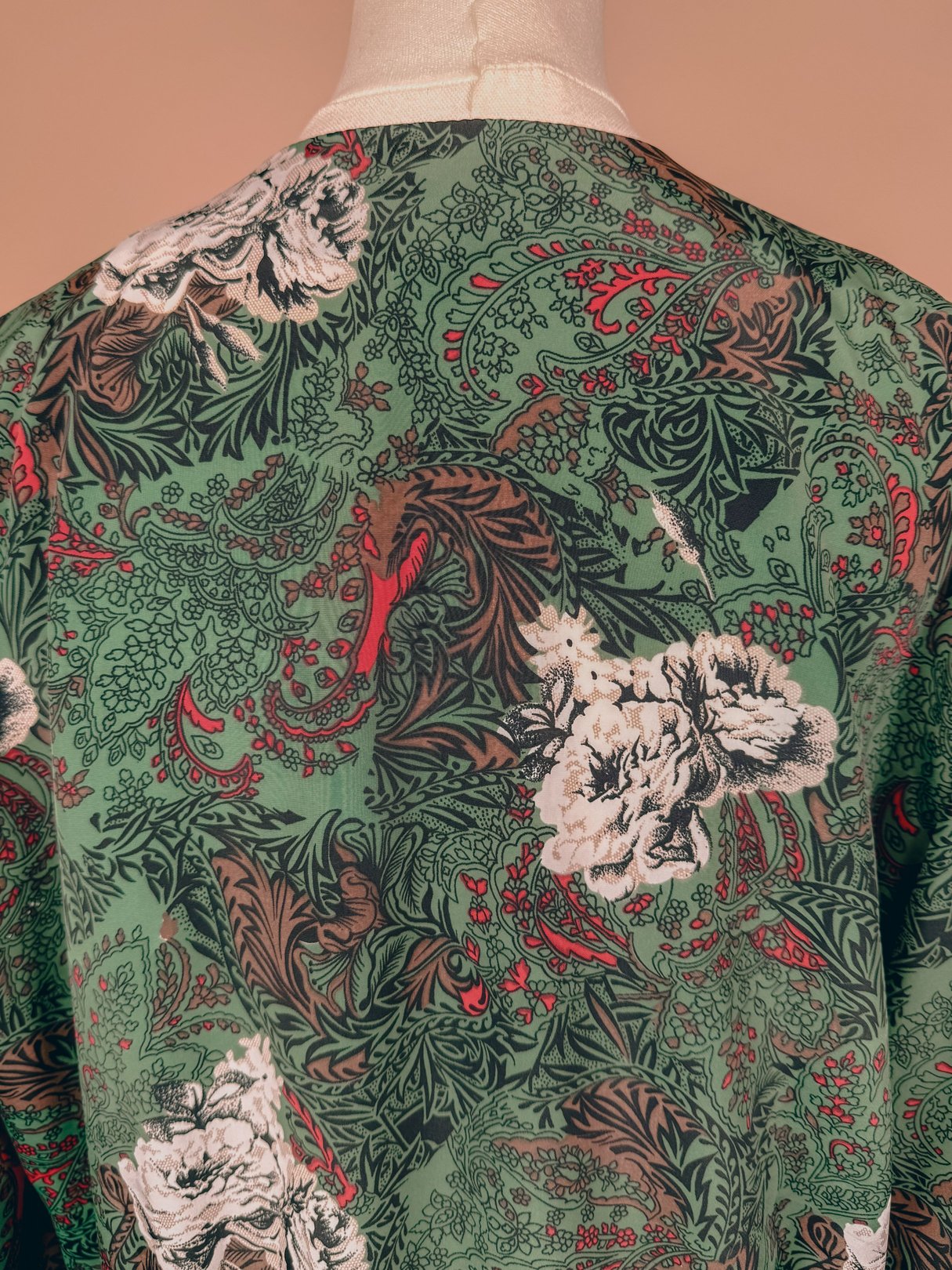 1980s women's Evergreen Bow Top in a red floral pattern with green foliage.