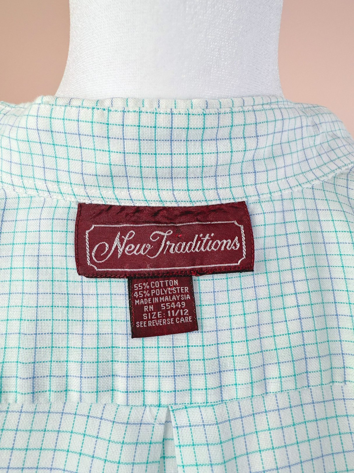 White checkered button down shirt with a tag that reads "New Traditions," made of 55% cotton and 45% polyester.