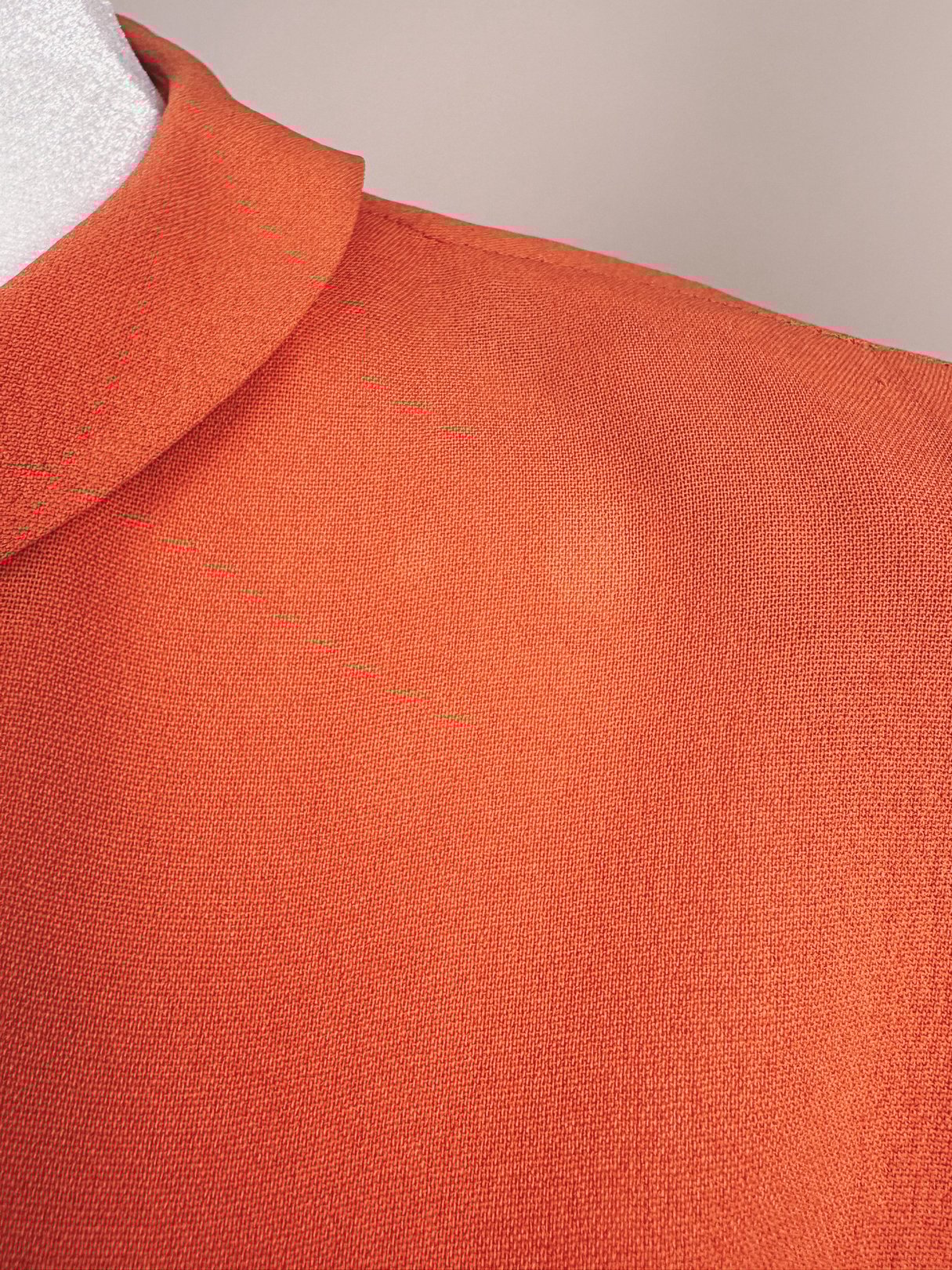 Coral 1940s recital dress featuring a structured collar and textured fabric.