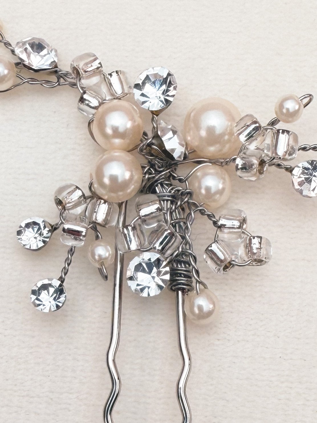 Silver hair pin adorned with pearls and sparkling crystals, featuring a 1970s-inspired design.