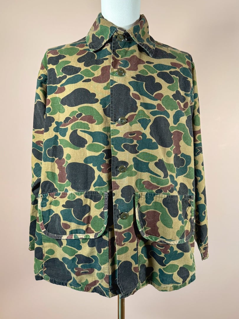 Men's 1970s Jim "Catfish" Hunter camo jacket in camouflage green with large front pockets.