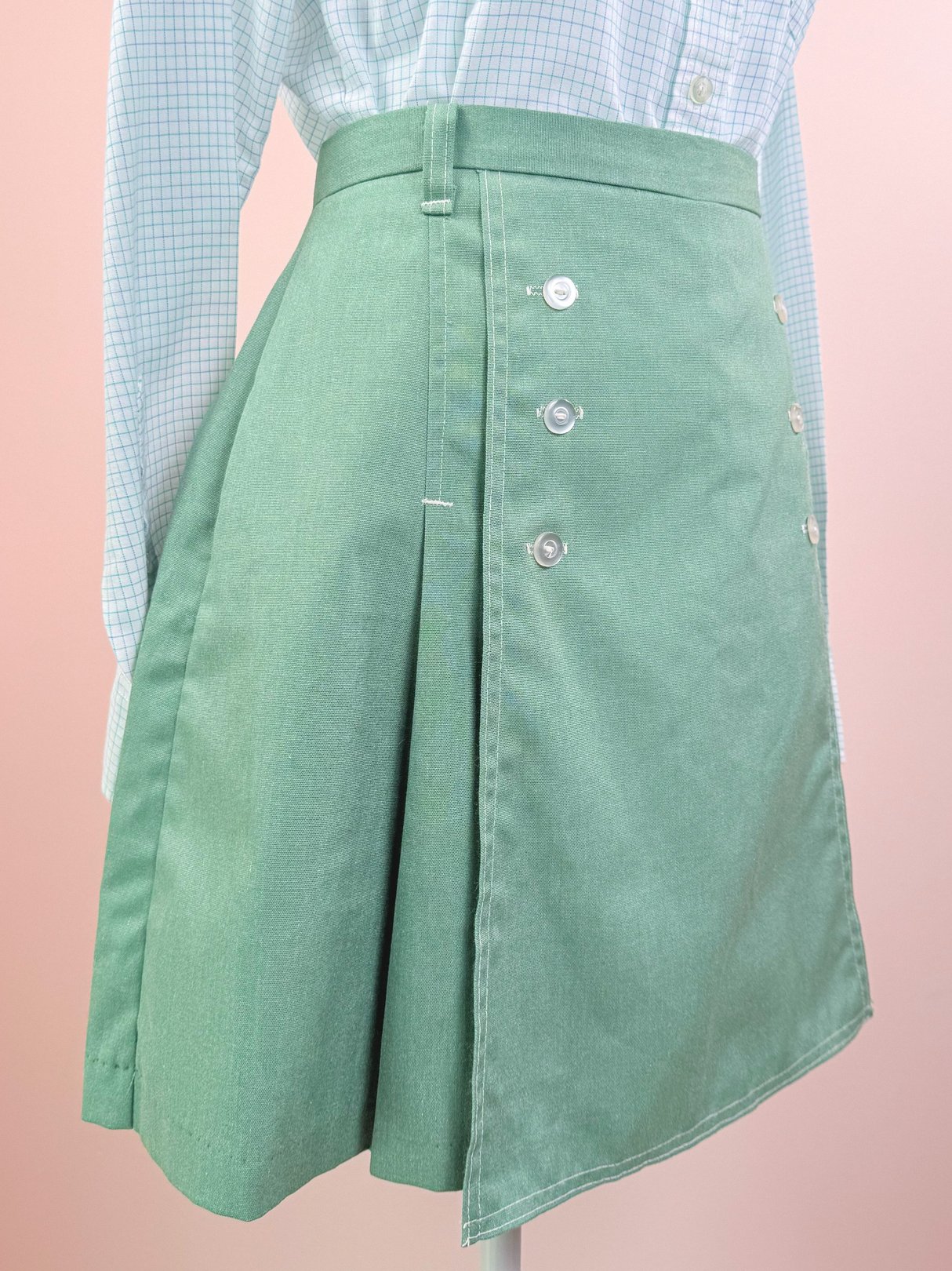 Green 1970s women's skort featuring a button detail on one side.