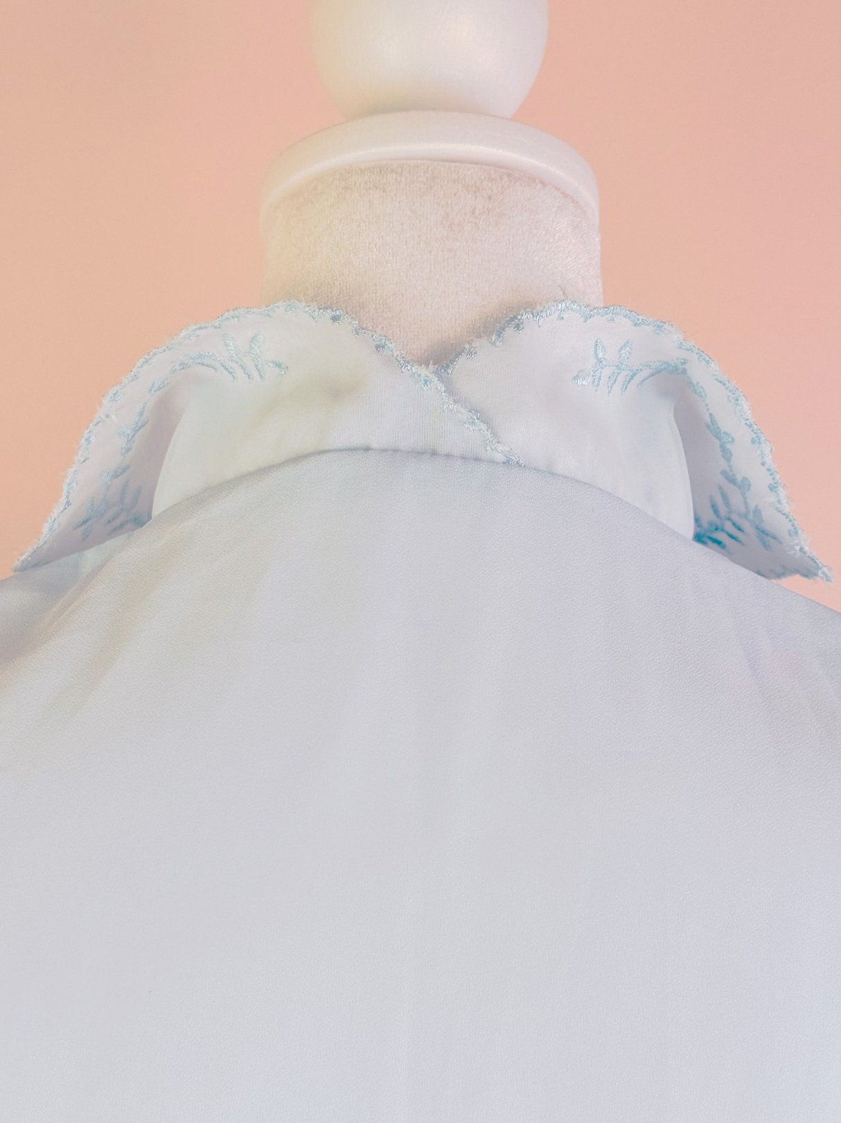 Powder blue blouse with a detailed embroidered collar, designed for women, reflecting a 1950s style.