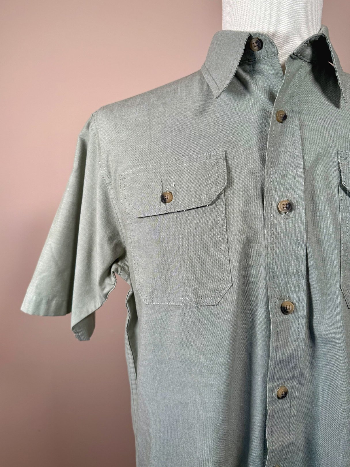 Sage green men's camp shirt from Wrangler Authentics featuring a button-up front and two chest pockets.