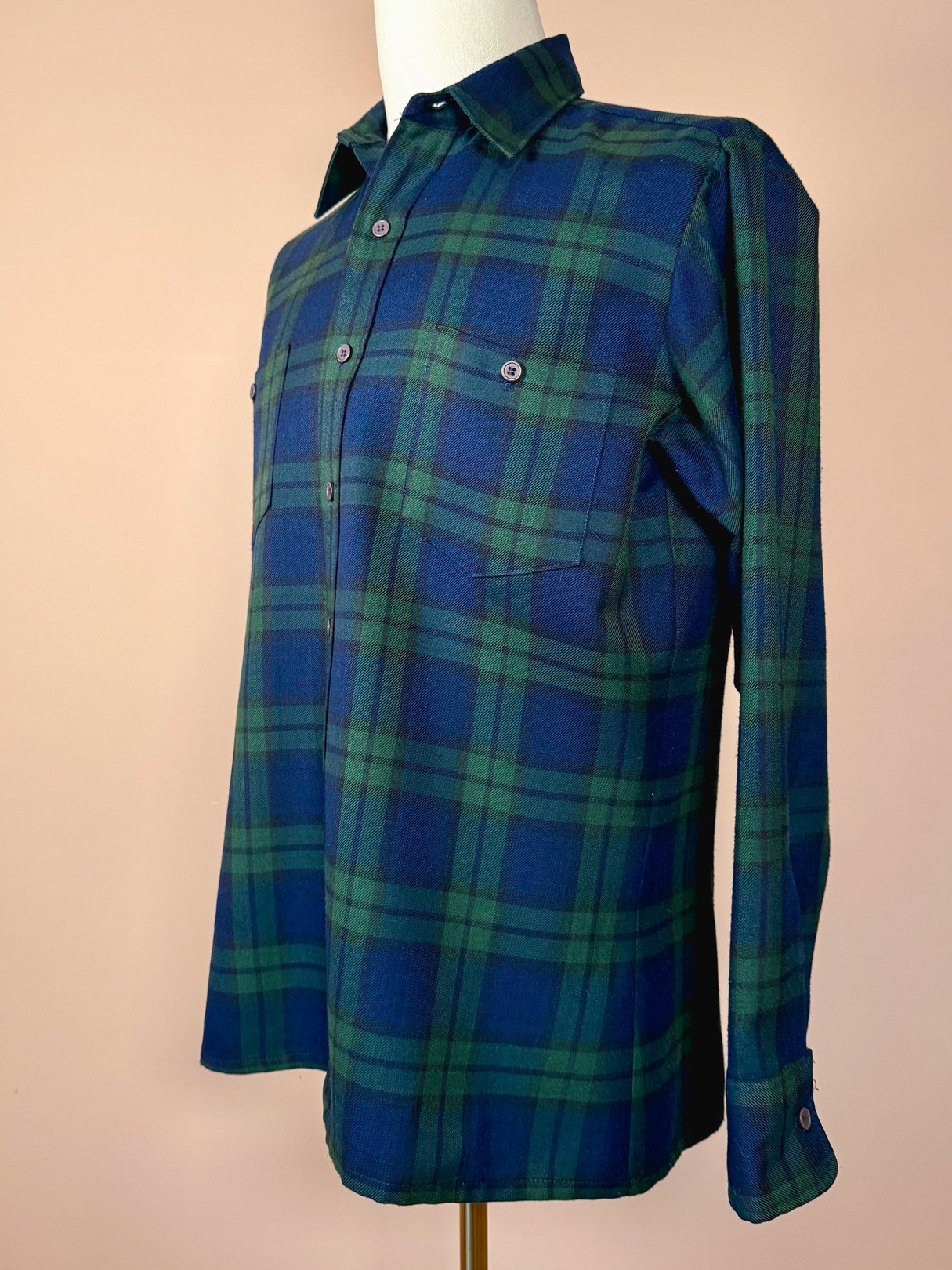 Navy blue men's plaid shirt featuring a forest design, typical of the 1950s, with button-up front and twin chest pockets.