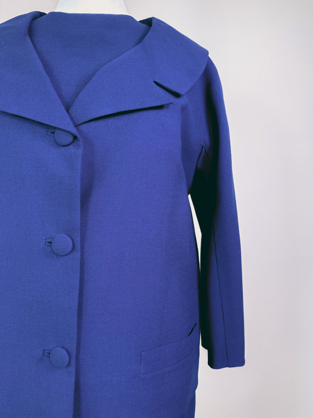 Navy blue 1960s women's dress set featuring a large lapel, button closures, and side pockets.