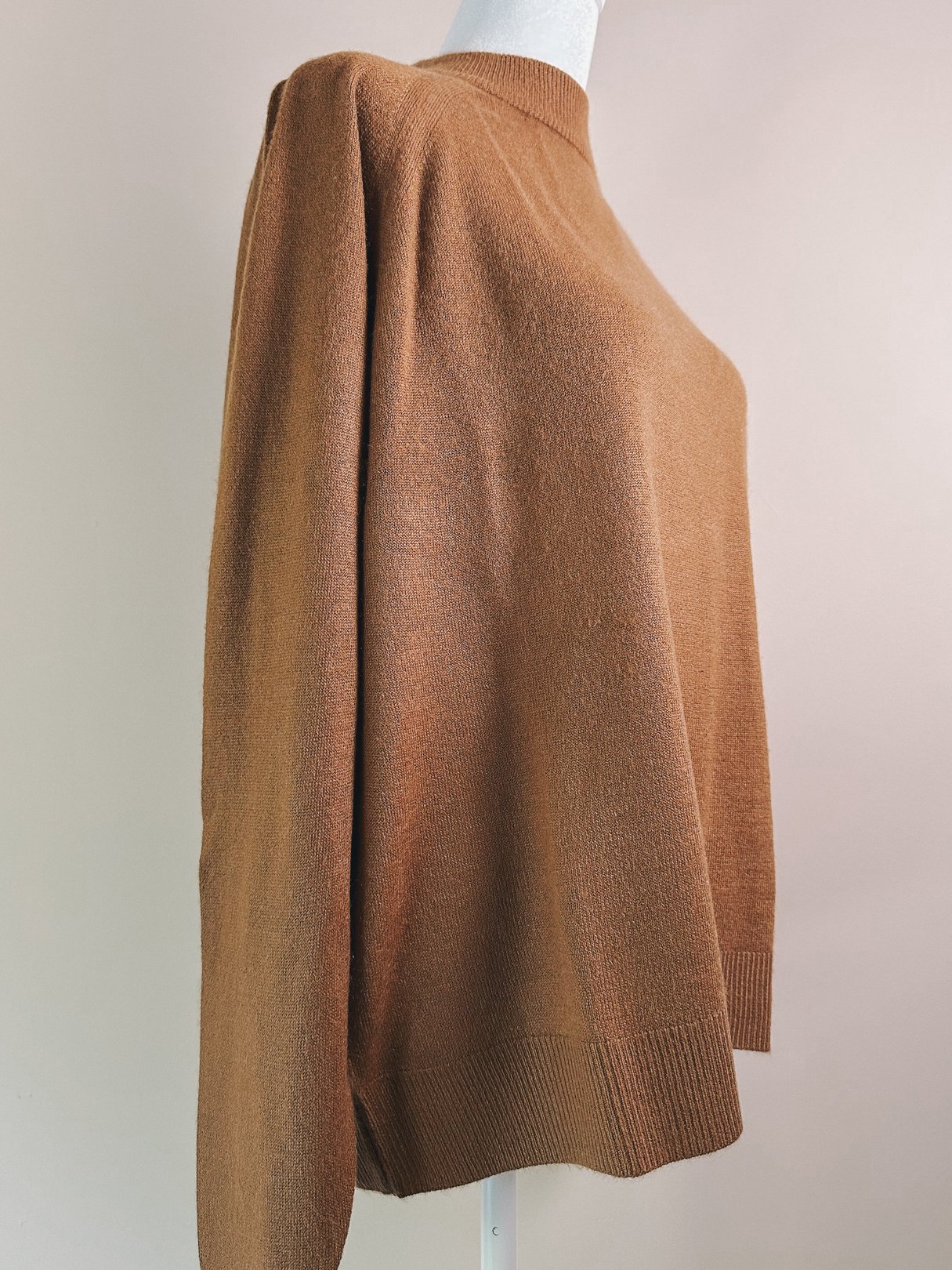 Caramel brown mock neck sweater for women, featuring a relaxed fit and dropped shoulder design, inspired by 1960s fashion.