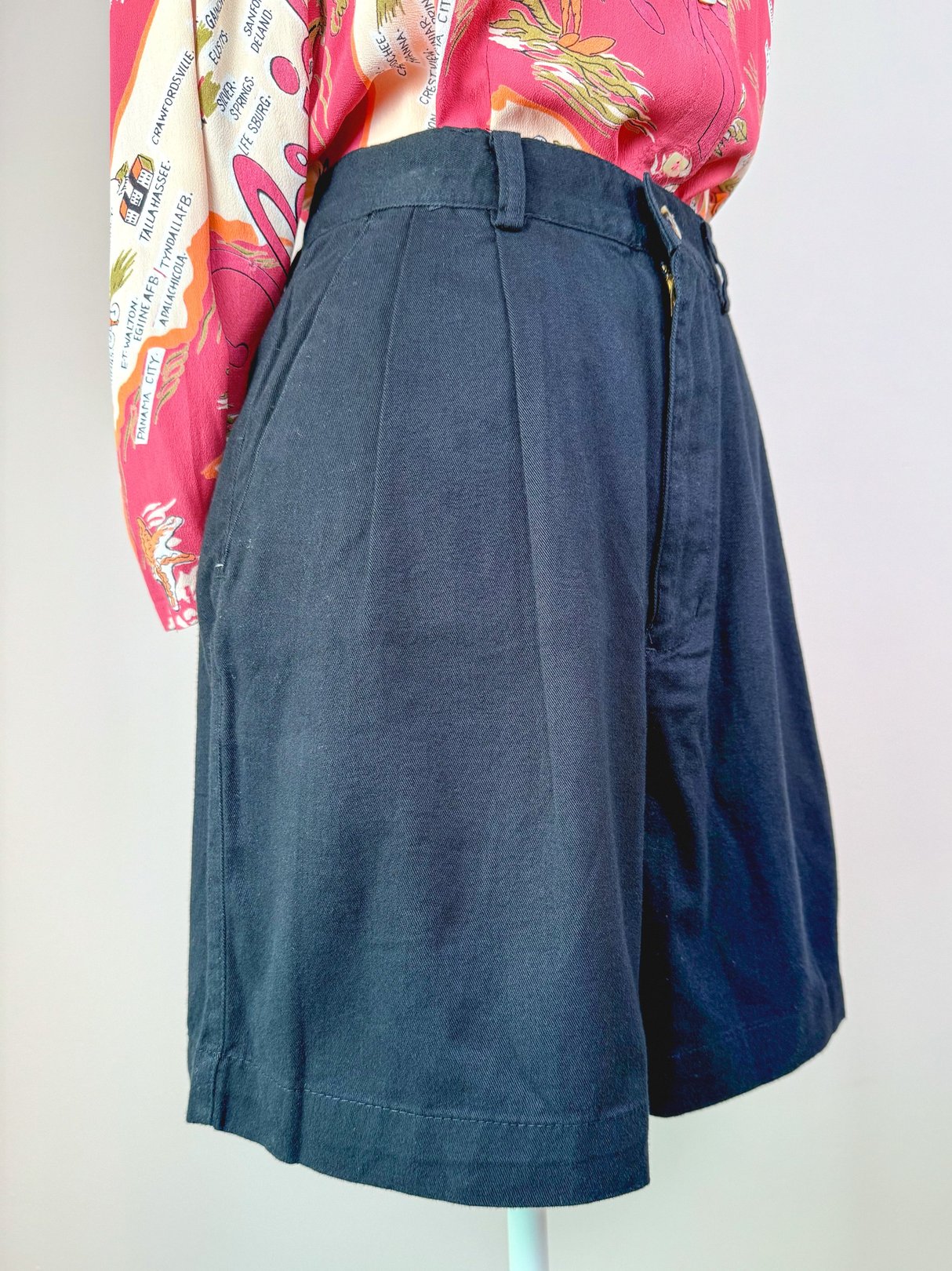 Black women's shorts from the 1980s with a high waist and pleated front.
