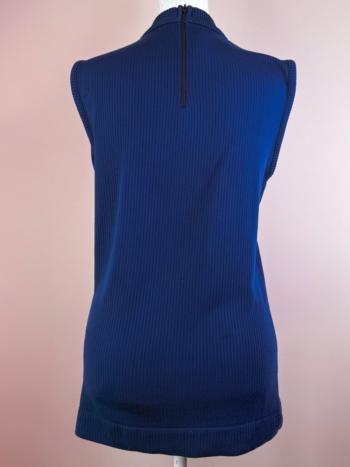 Navy blue retro ribbed mock neck top for women, featuring a sleeveless design and a back zipper, inspired by the 1970s era.