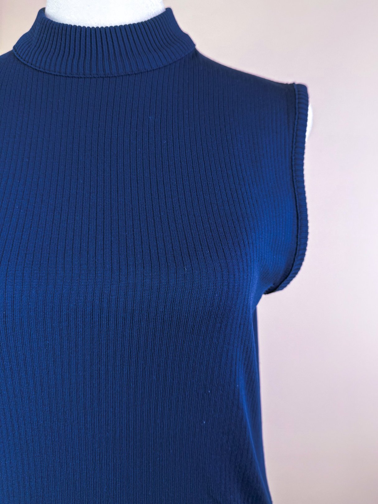 Navy blue retro ribbed mock neck top with sleeveless design, inspired by 1970s fashion.