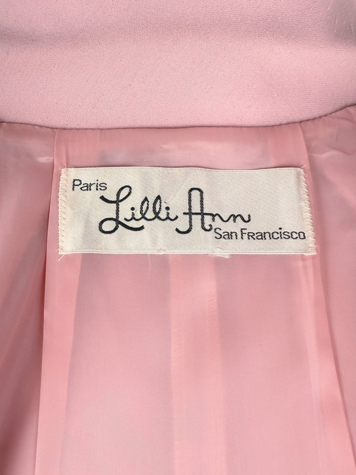 Lilli Ann blush pink label from a women's 1970s three-piece suit.