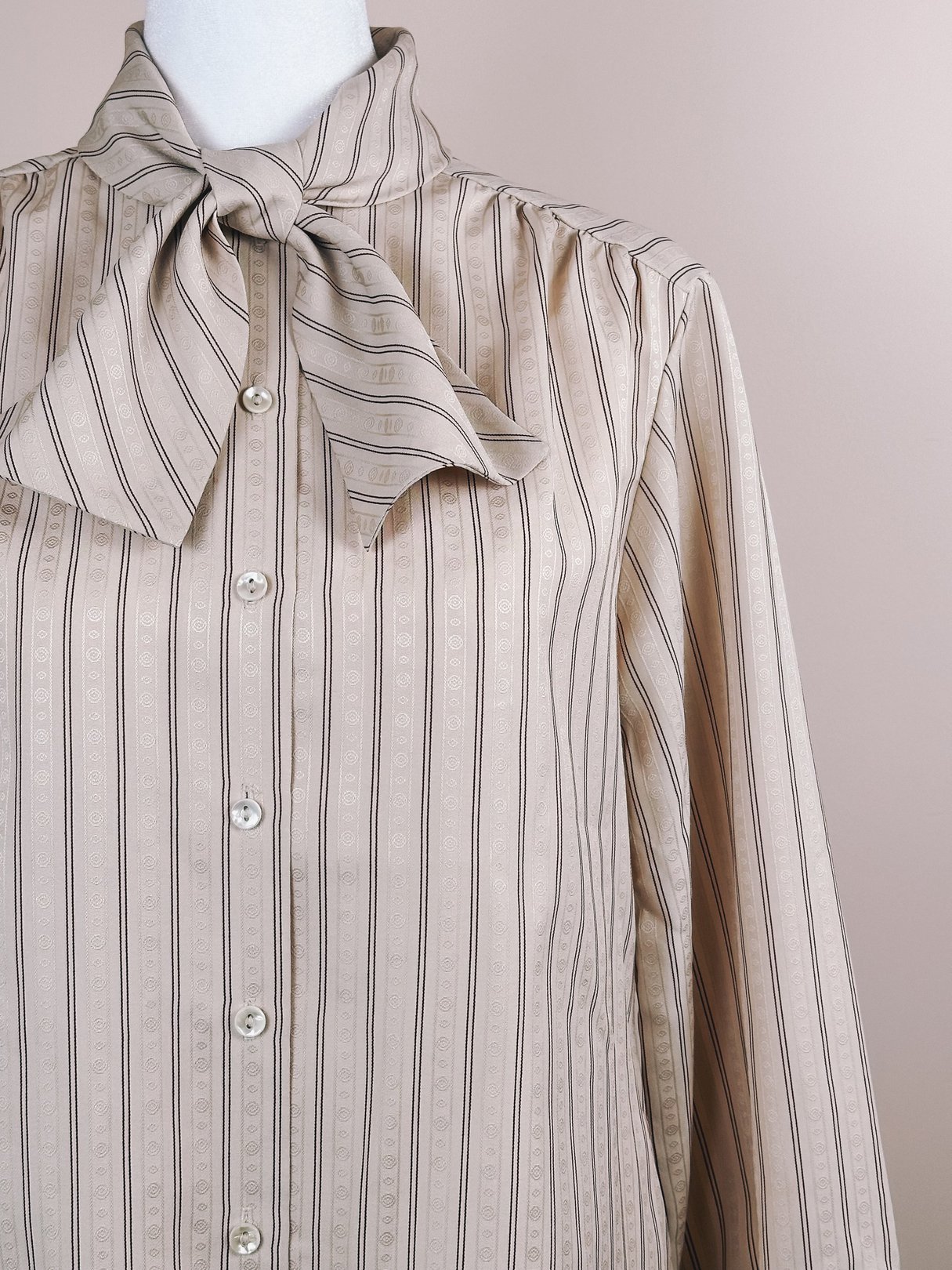 Maroon striped blouse with a bow tie collar and button front, featuring a tan color and long sleeves, from the 1980s for women.