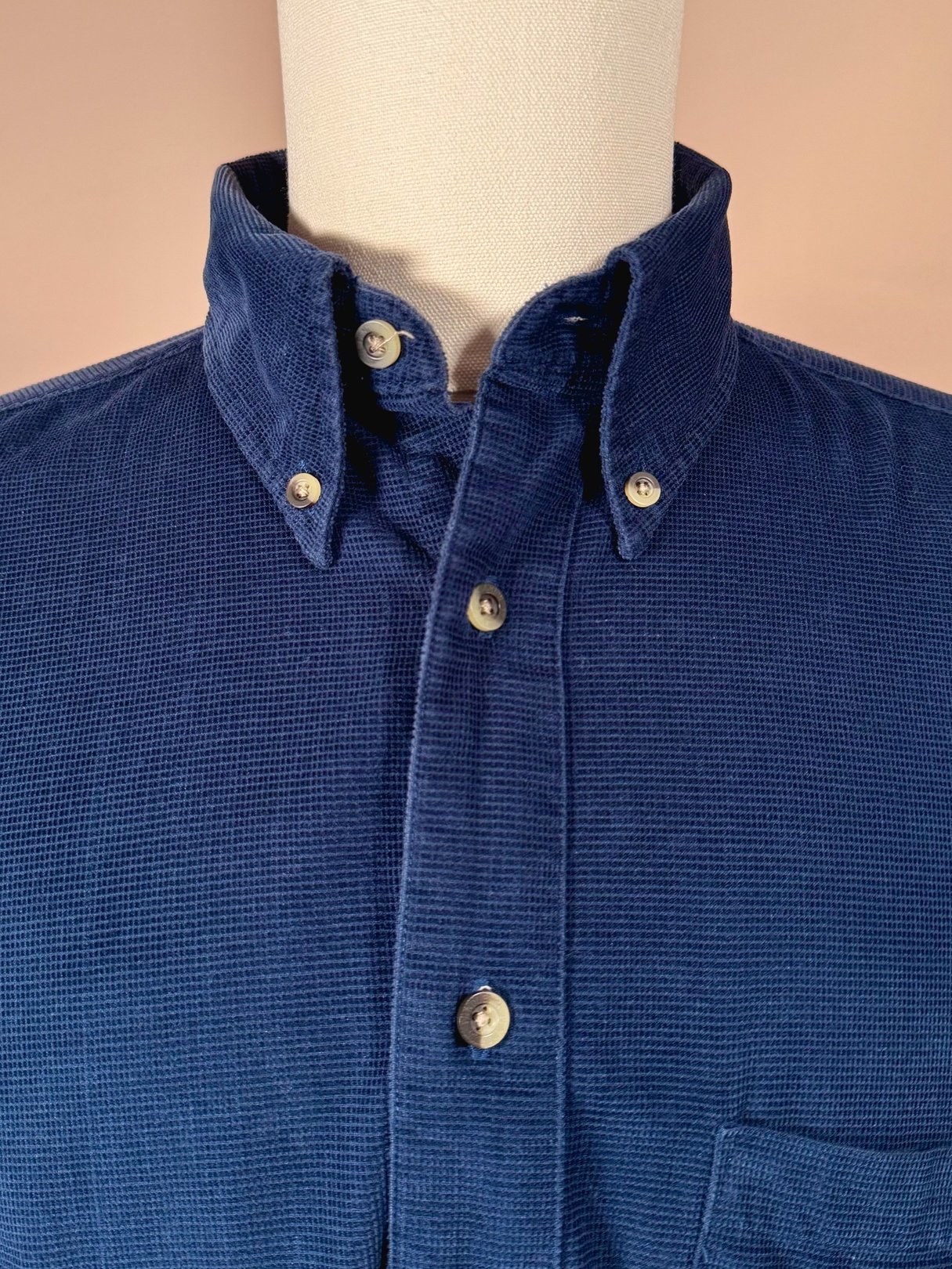 Navy blue men's cord shirt from the 1990s featuring a button-down collar and a chest pocket.