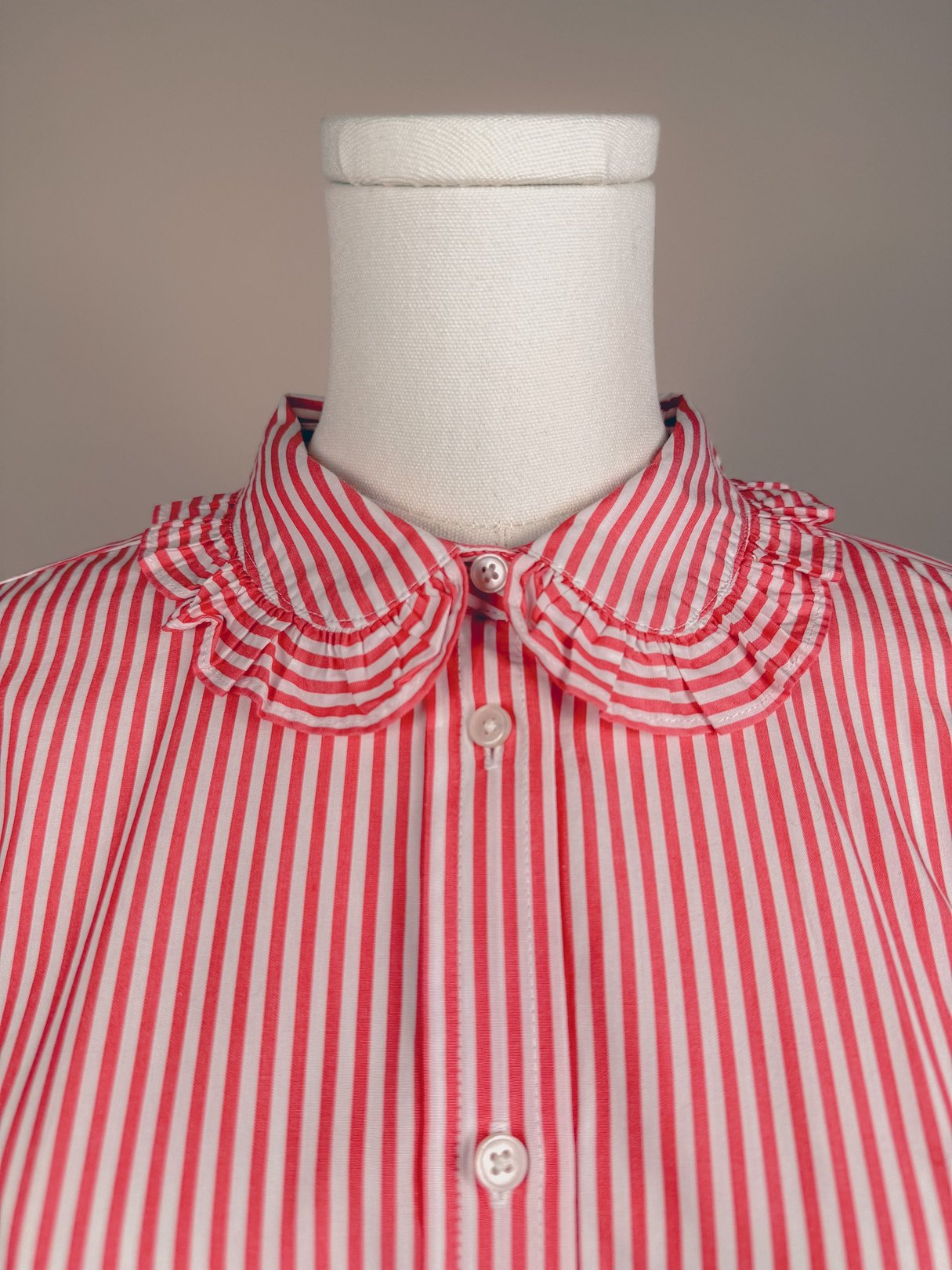 Red and white striped button-down top featuring a ruffled collar, designed for women in a 1970s style.