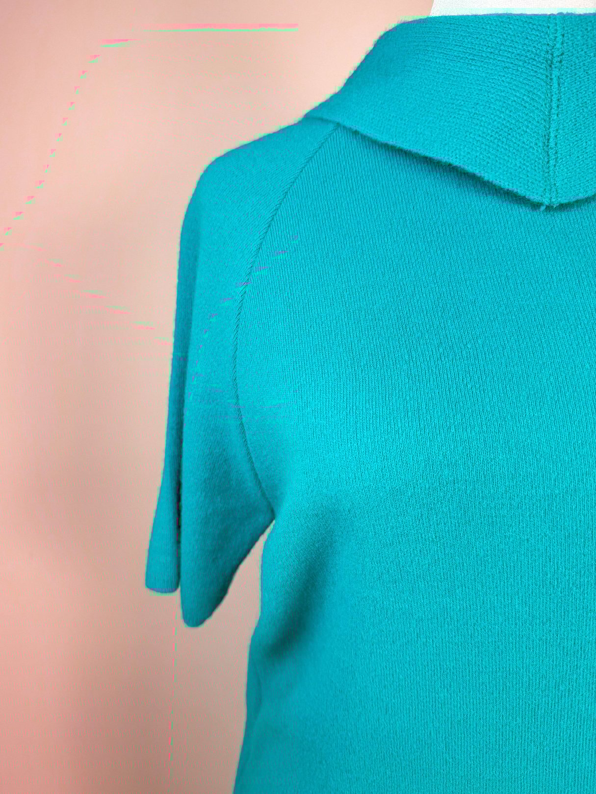 Teal green knit top with a rounded collar and short sleeves from a women's 1960s skirt set.