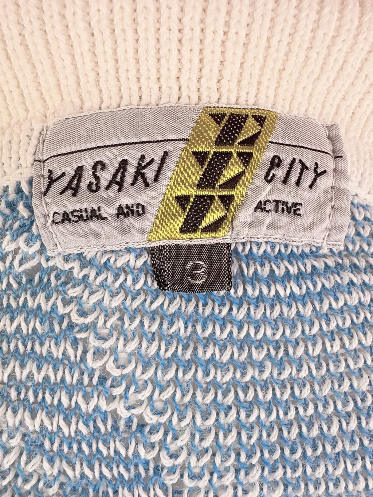 Yasaki Knit Polo Sweater in white from the 1980s featuring a textured knit and a label indicating size 3.